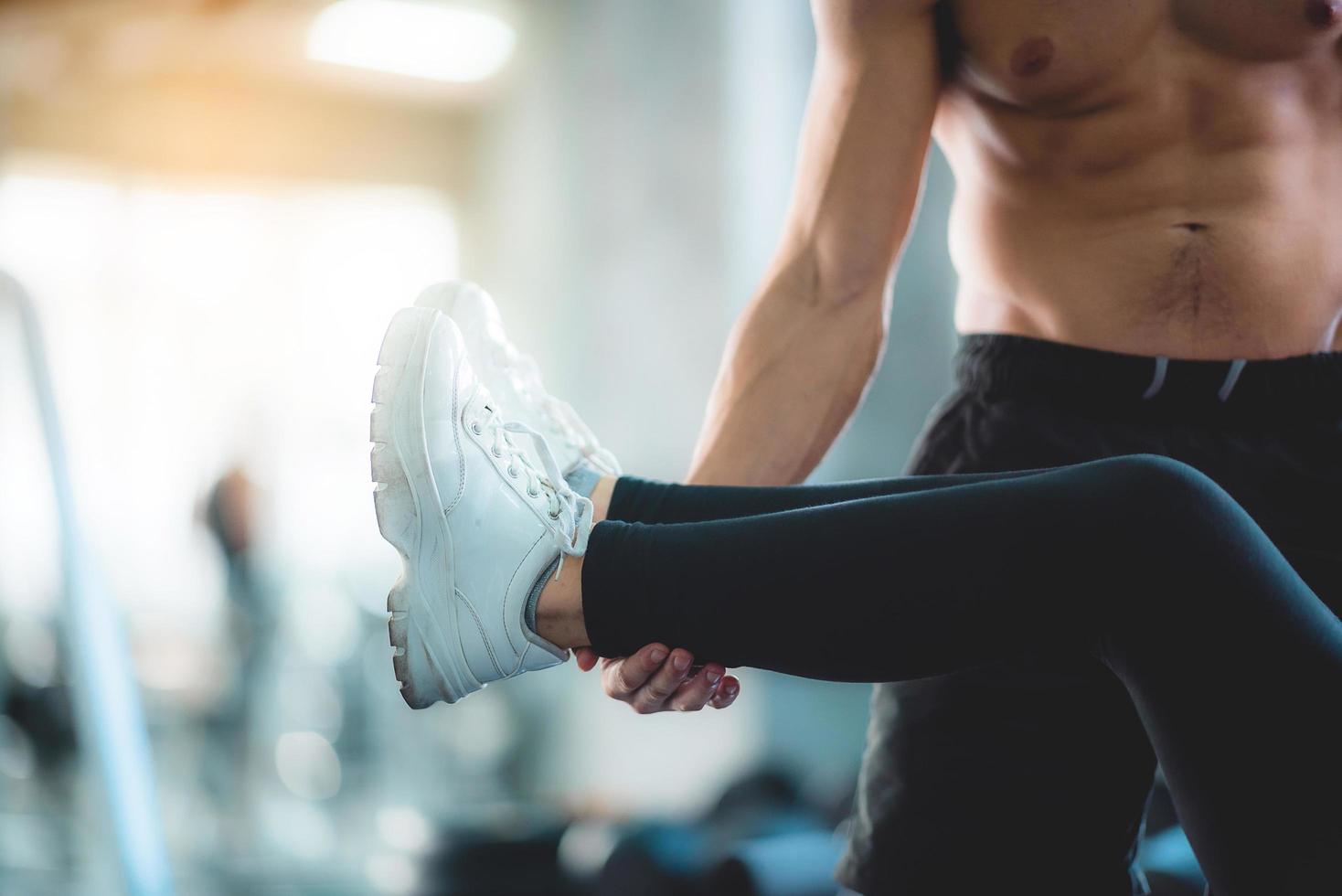 Trainer holding feet during exercise photo