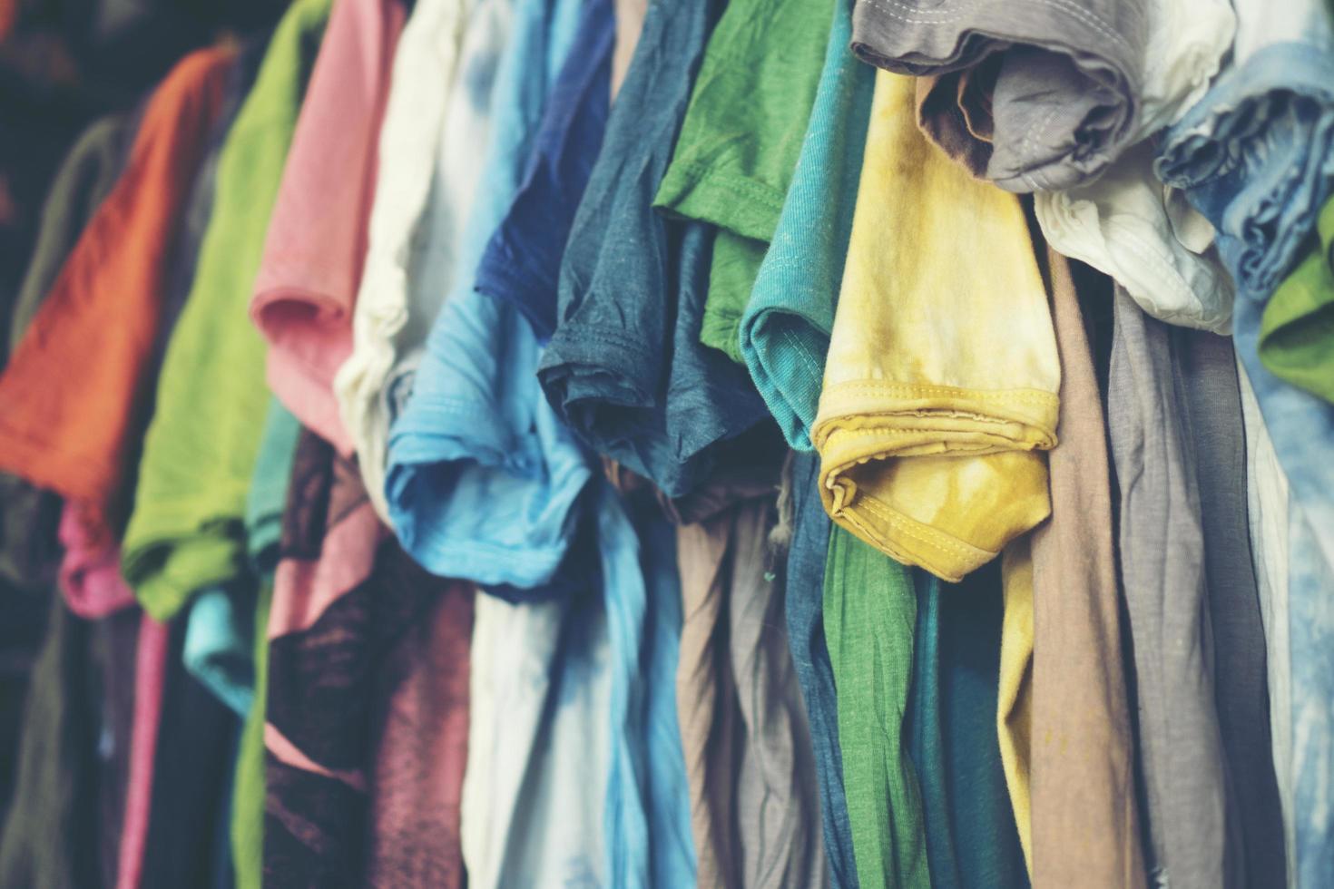 Colorful t-shirts hanging up photo