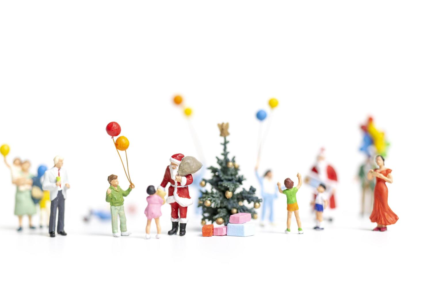 Miniature Santa Claus holding gifts for a happy family, Christmas and Happy New Year concept photo