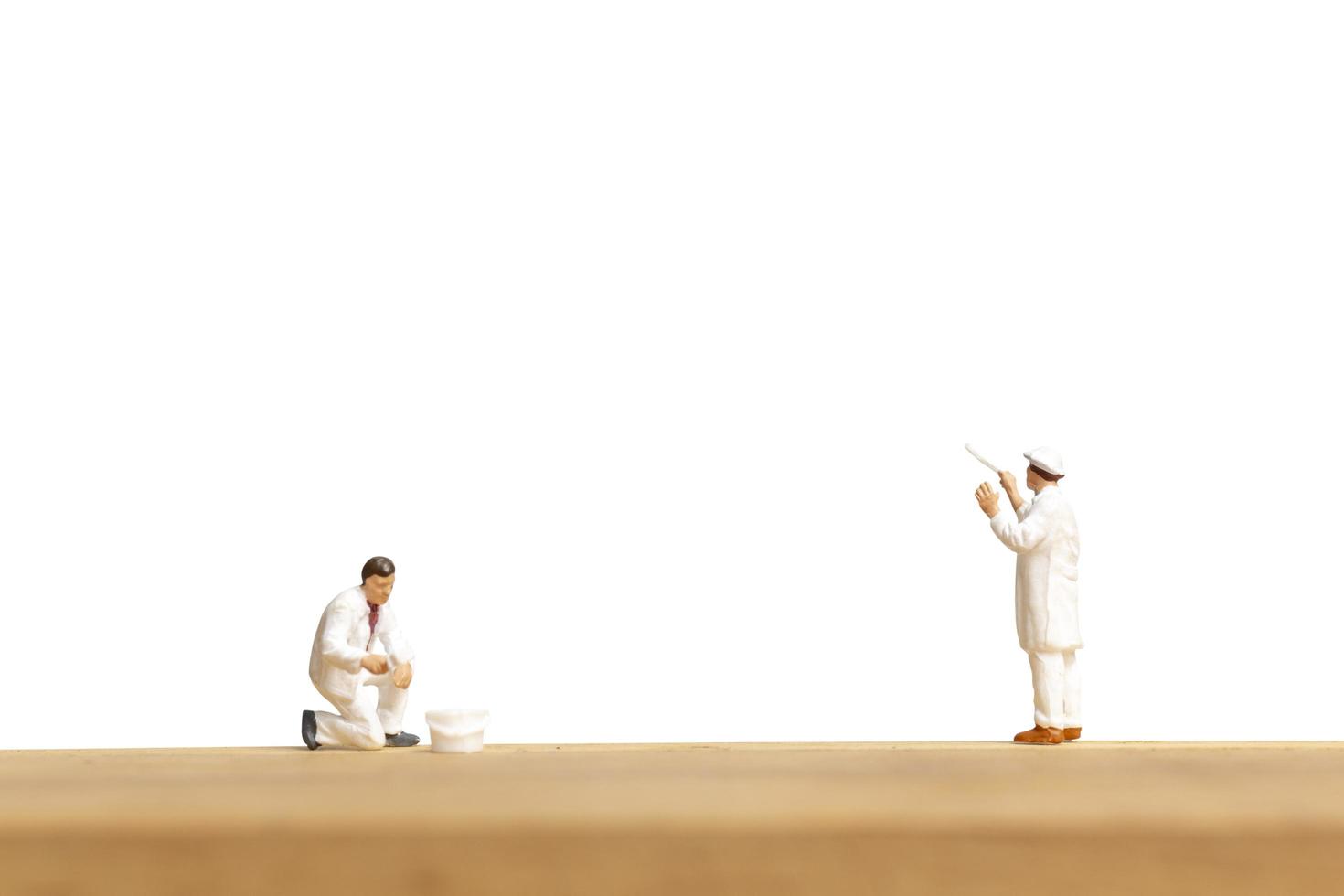 Miniature painters holding a brush isolated on a white background photo