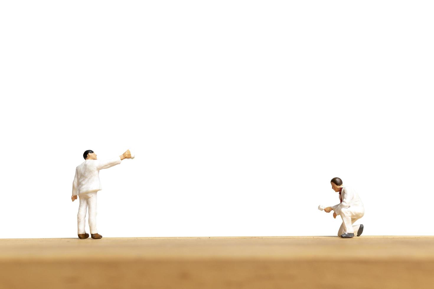 Miniature painters holding a brush isolated on a white background photo