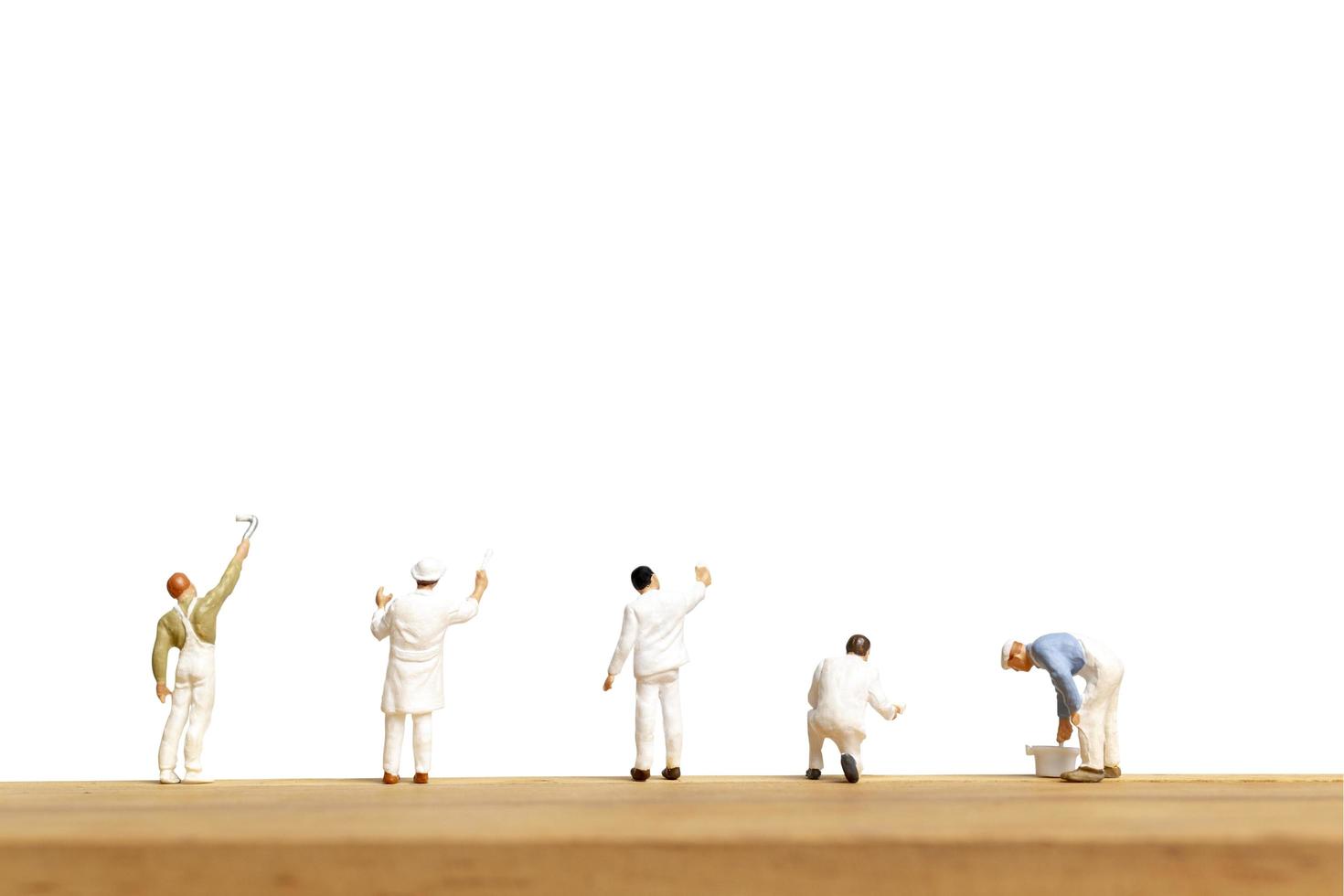 Miniature painters holding a brush isolated on a white background photo