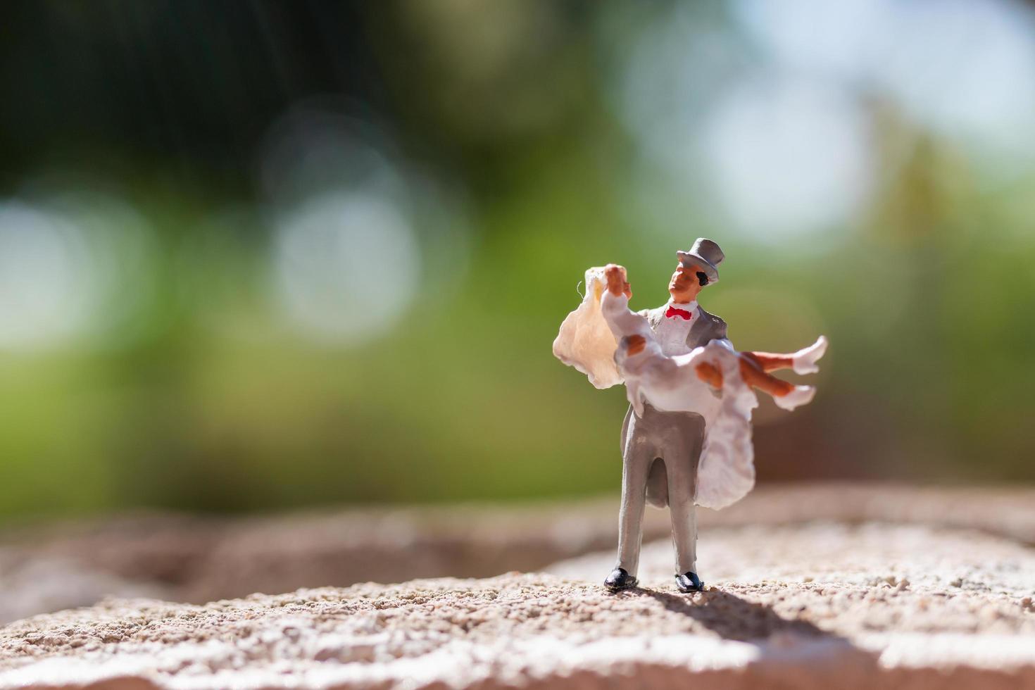 Miniature couple standing in the park photo