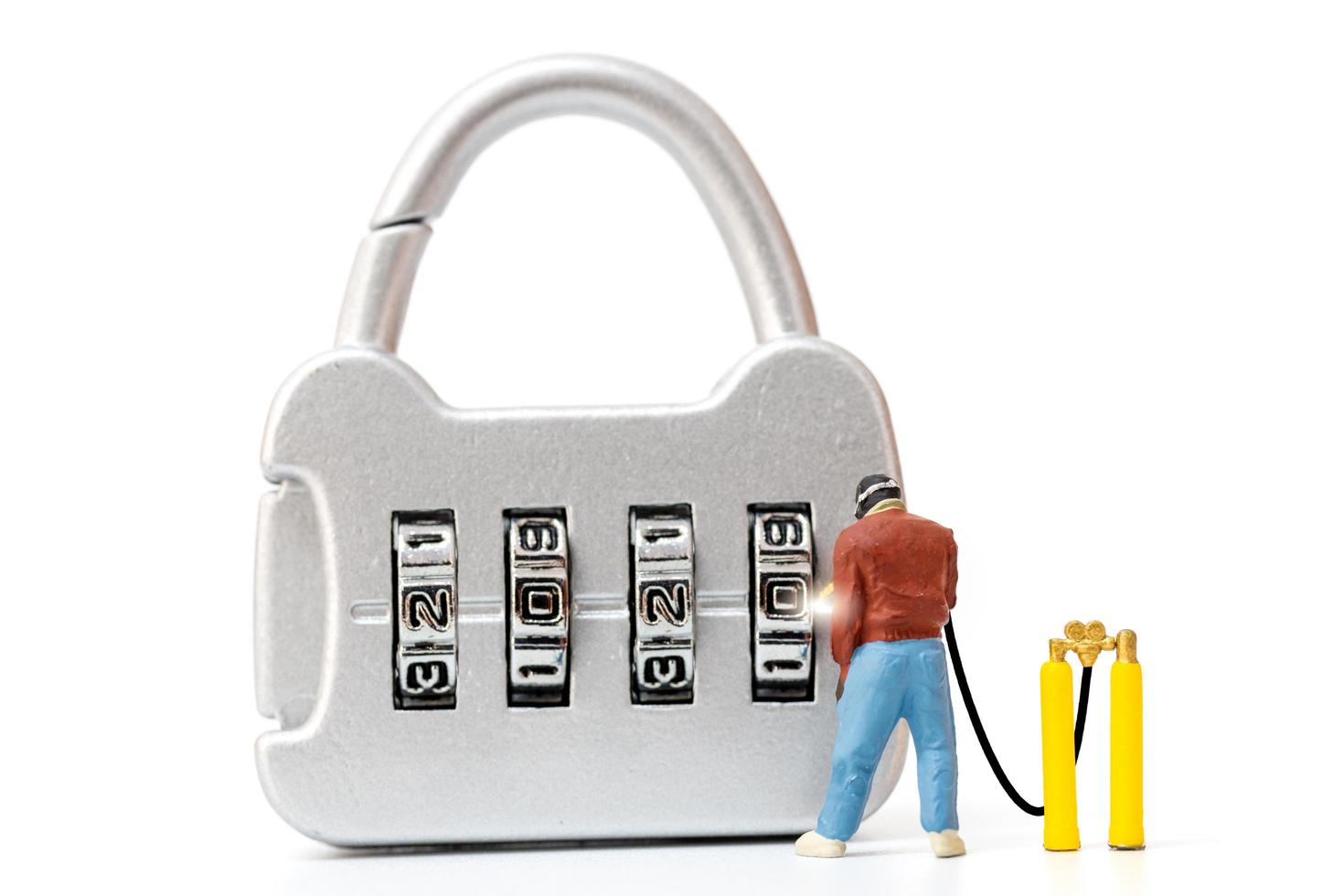 Miniature person working on a combination lock photo