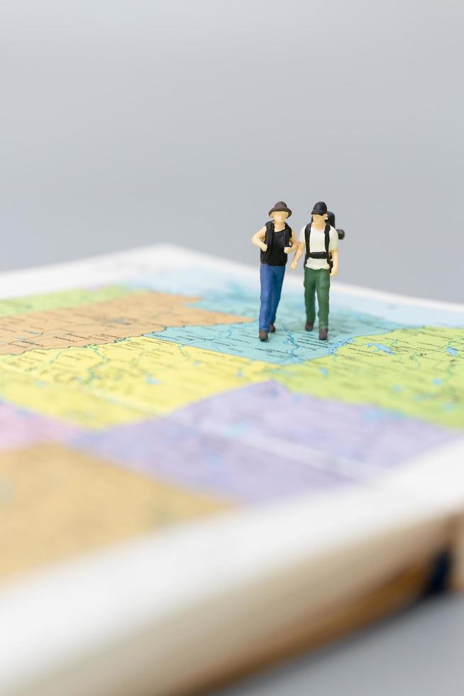 Pareja en miniatura enamorada en moto, concepto de aventura y vacaciones foto