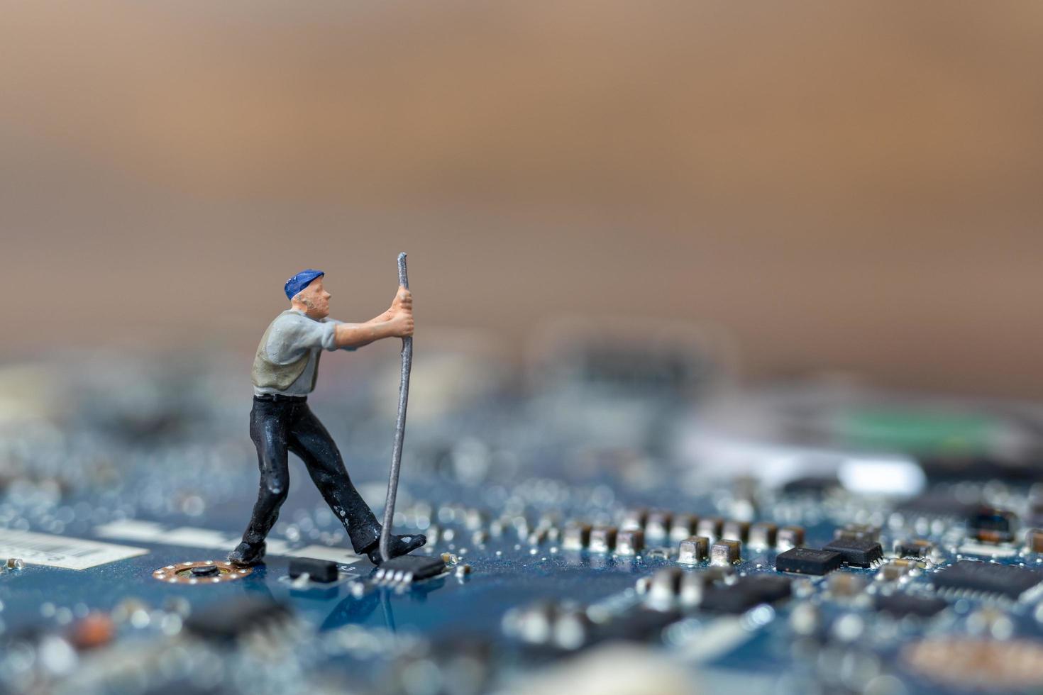 Miniature person working on a CPU board, technology concept photo