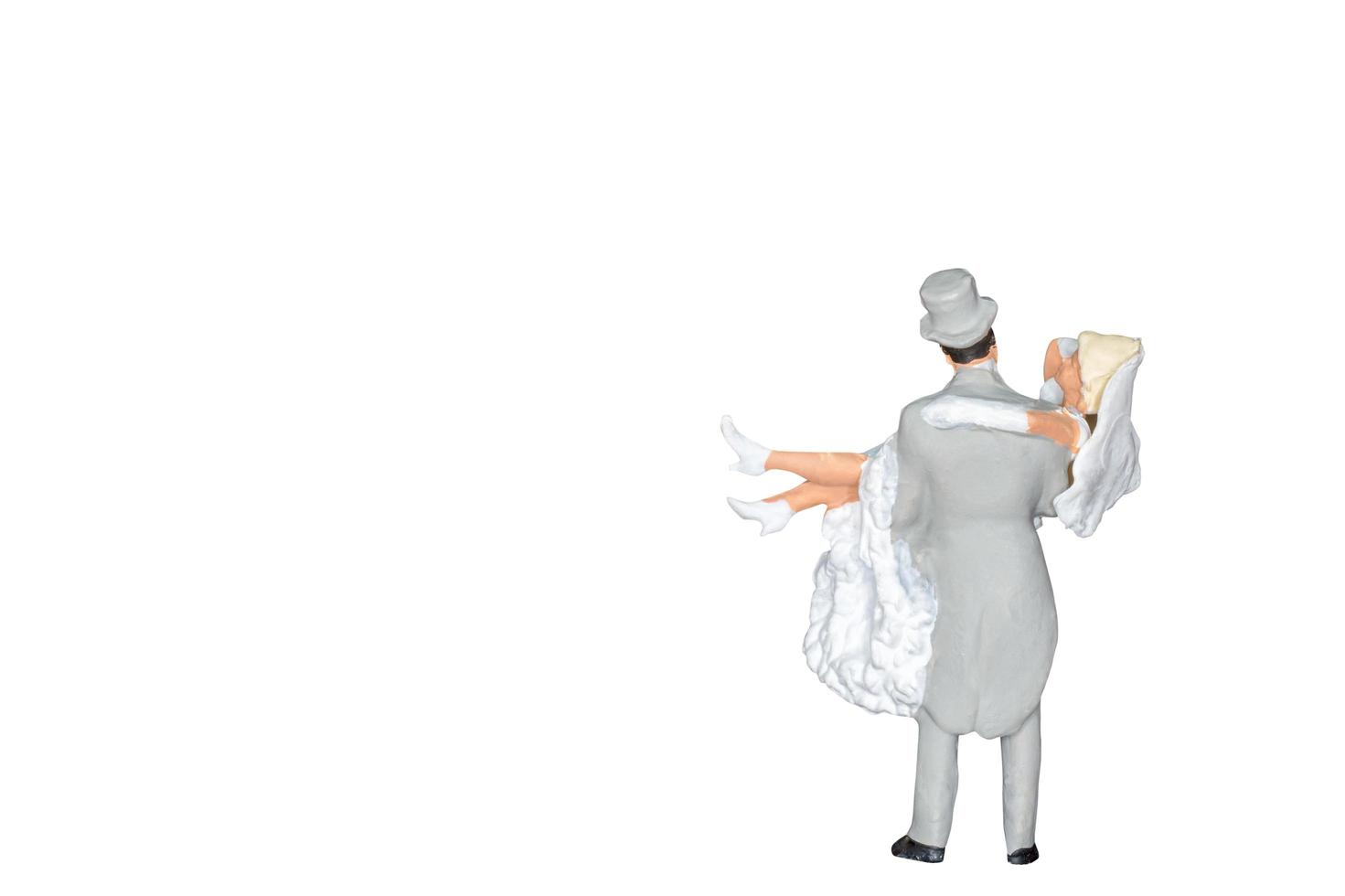 Miniature wedding bride and groom isolated on a white background photo