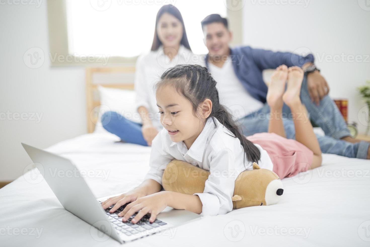 Happy family on a bed photo