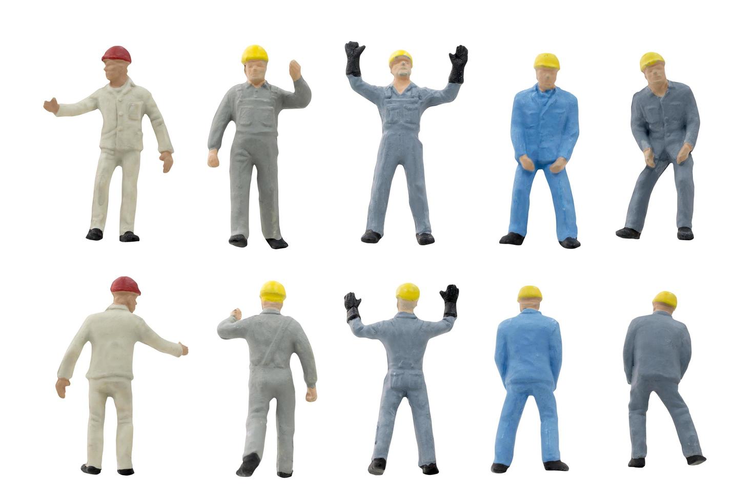 Miniature construction workers on a white background photo