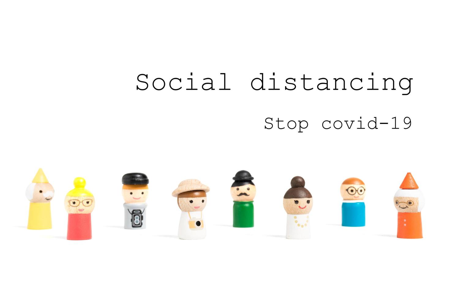 Stop COVID-19 social distancing text with miniature people on a white background, social distancing concept photo