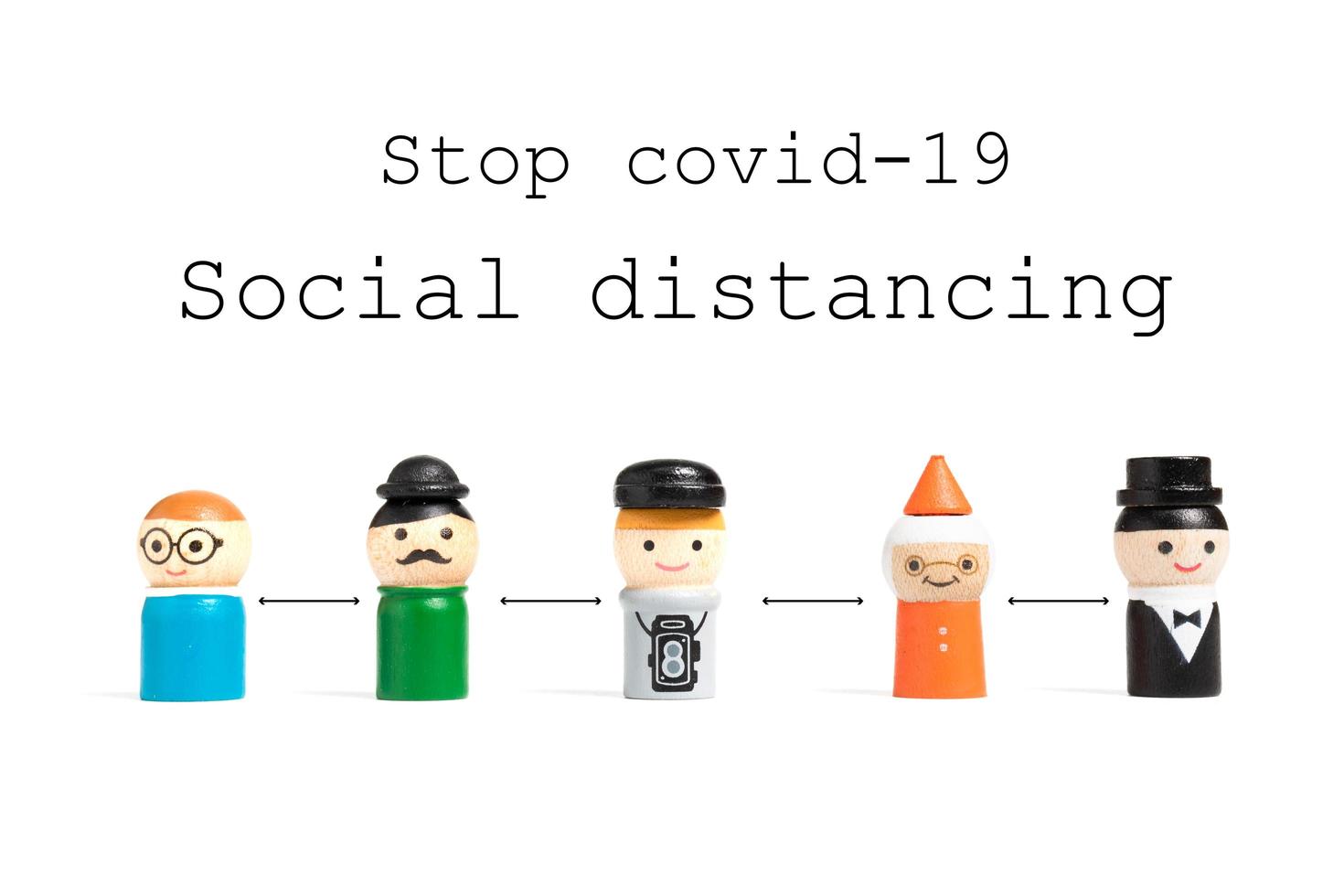 Stop COVID-19 social distancing text with miniature people on a white background, social distancing concept photo