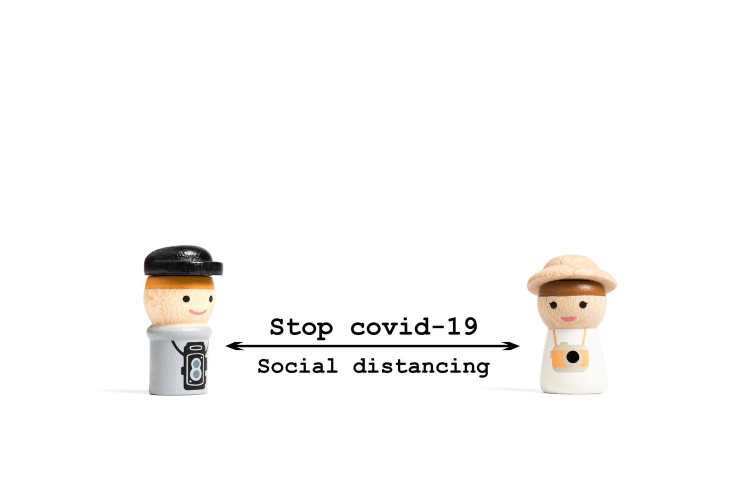 Detener el texto de distanciamiento social covid-19 con personas en miniatura sobre un fondo blanco, concepto de distanciamiento social foto