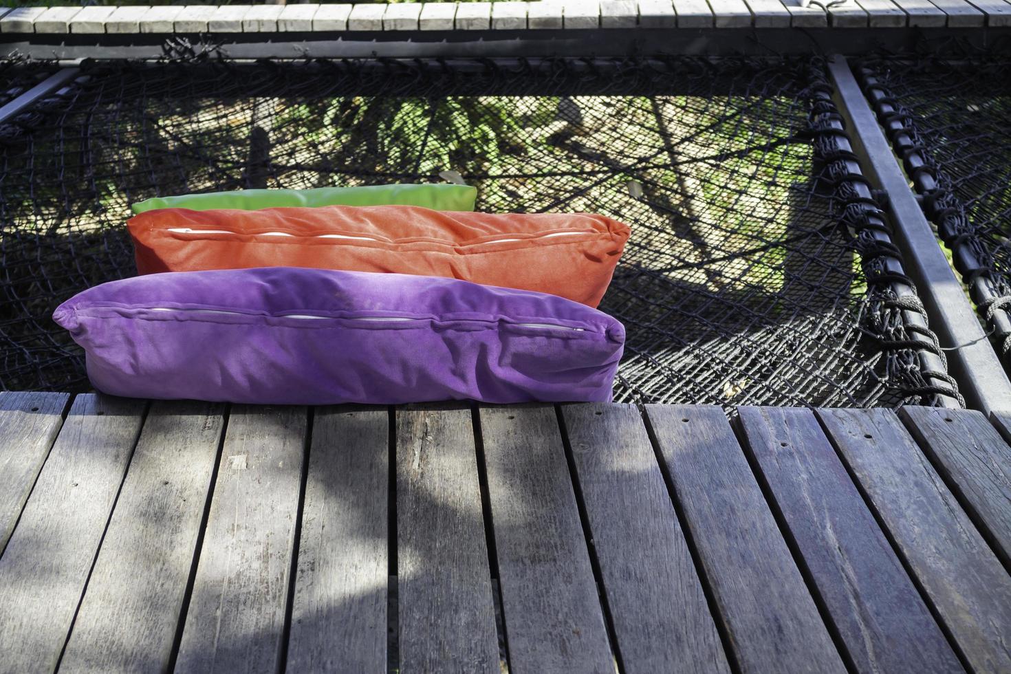 Colorful pillows on net seat photo