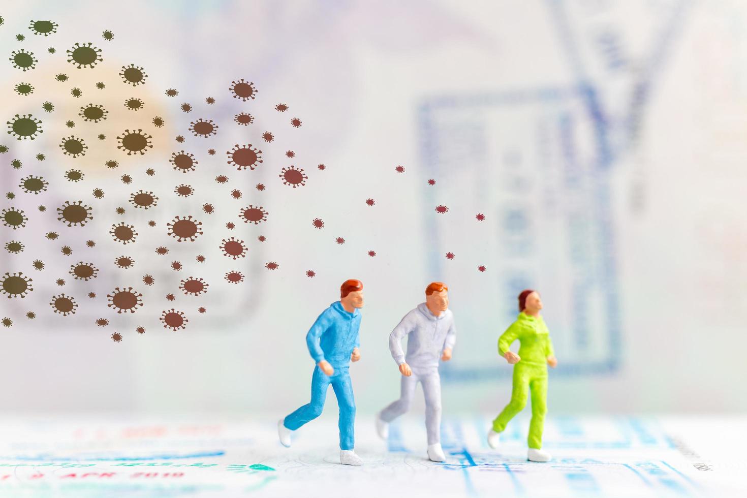 Miniature people running away from coronavirus 2019-nCoV flu infection, health crisis concept photo