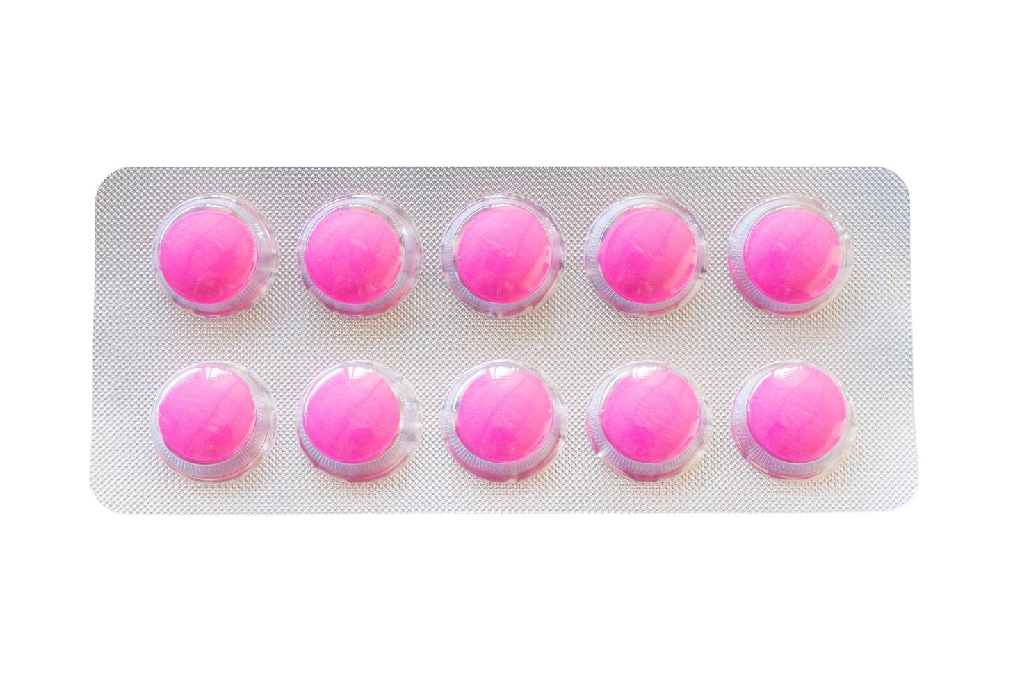 Pink pills in a blister pack isolated on a white background photo