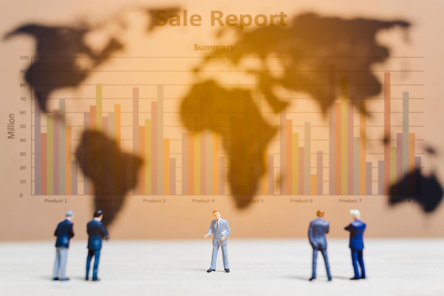 Miniature businessmen standing by a world map background, growing a business concept photo