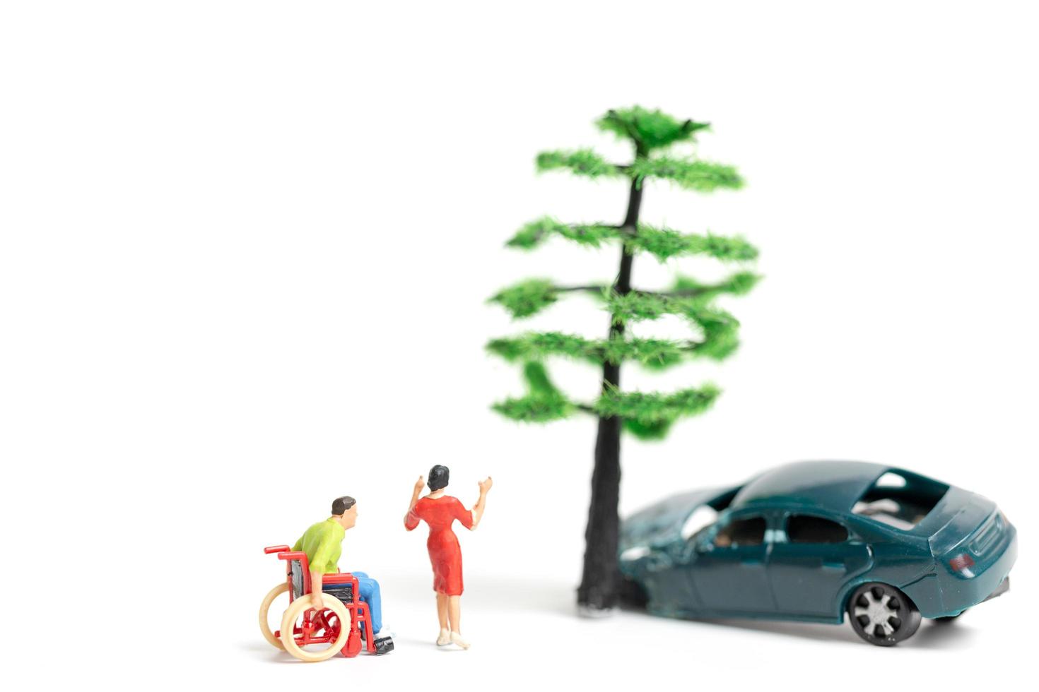 Miniature people at the scene of a car accident, car crash on a white background, drive safely concept photo