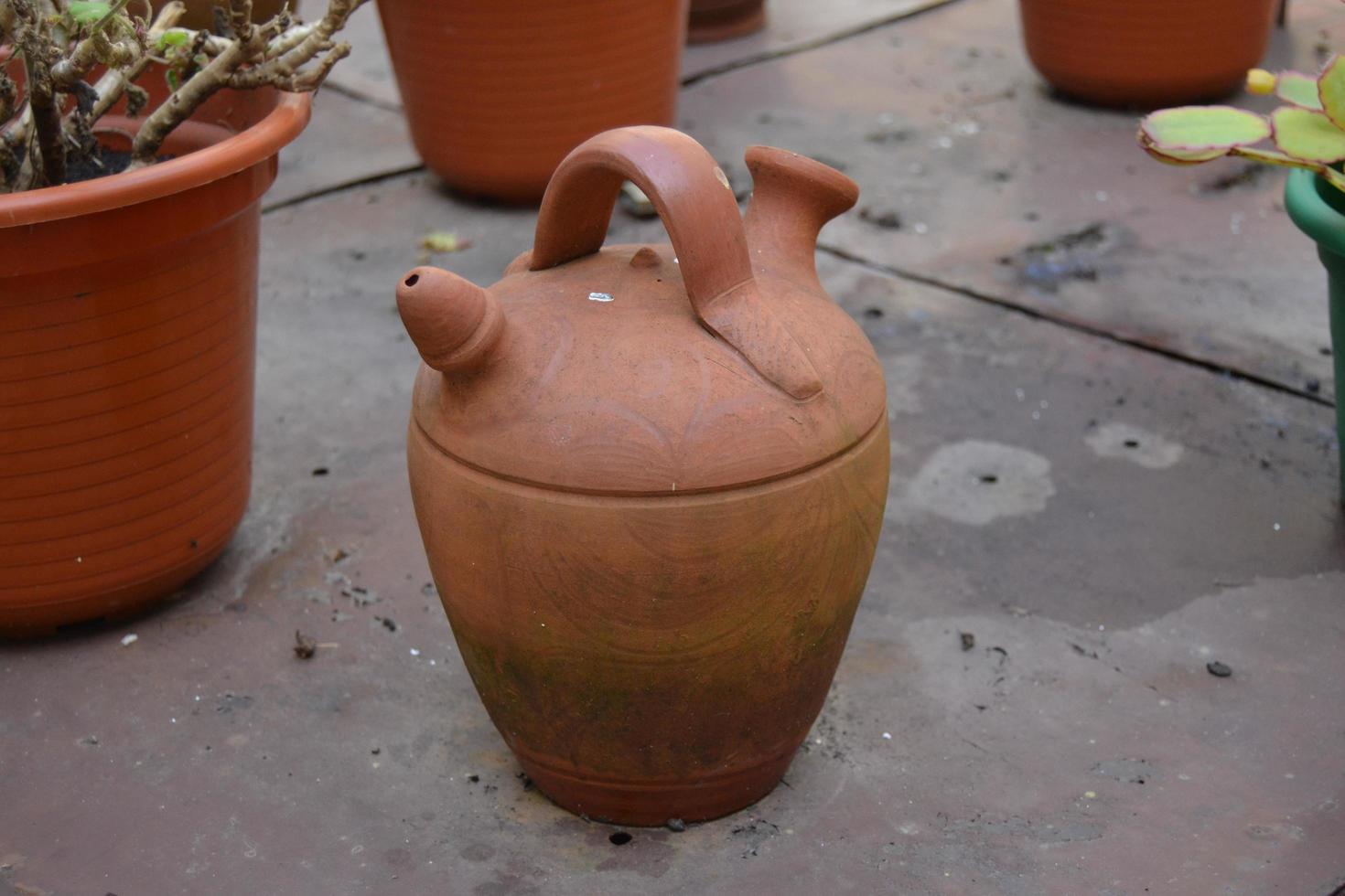 Old clay jug on the floor photo