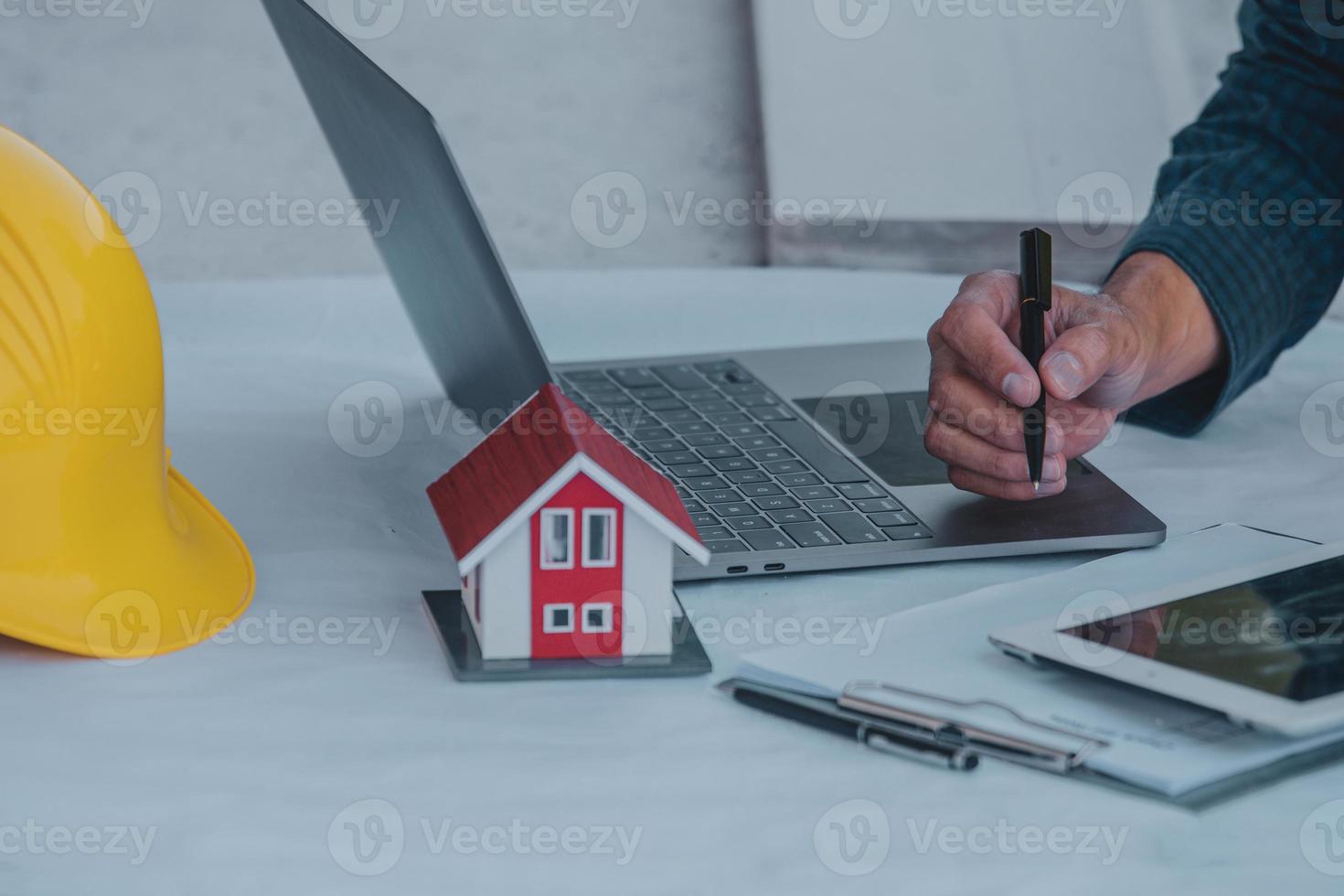 Architectural Engineer designs building construction for a house project photo