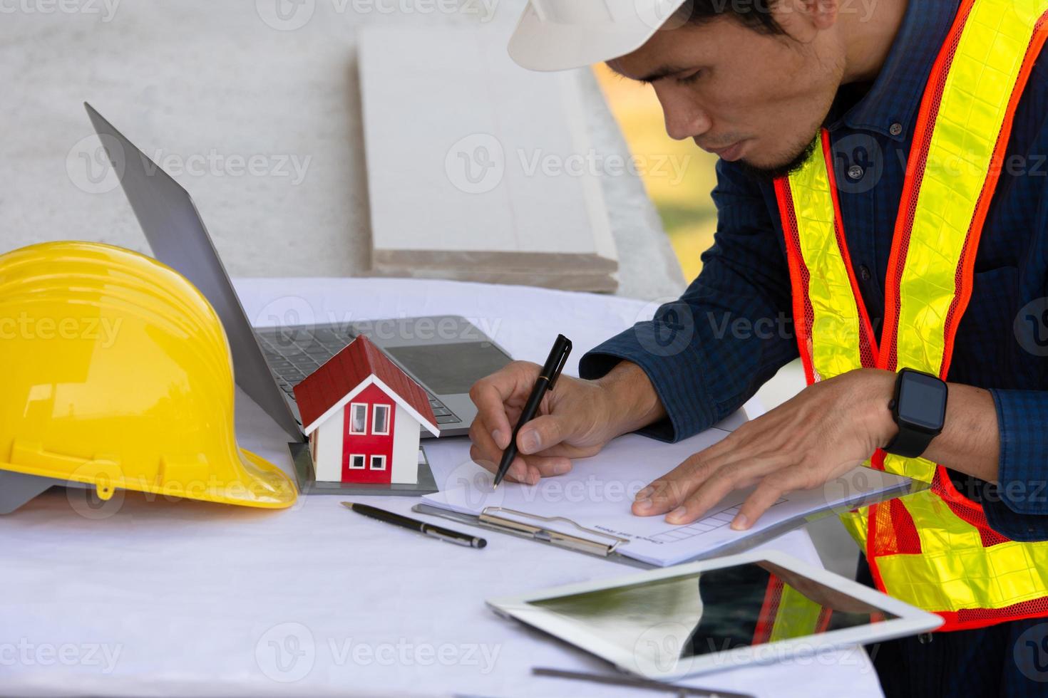 Architectural Engineer designs building construction for a house project photo