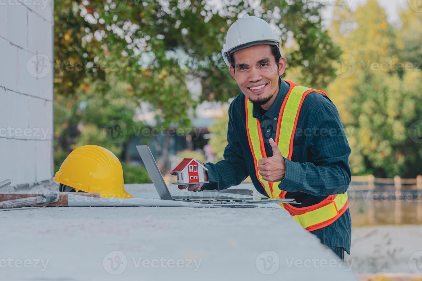 Engineer working on laptop on site construction photo