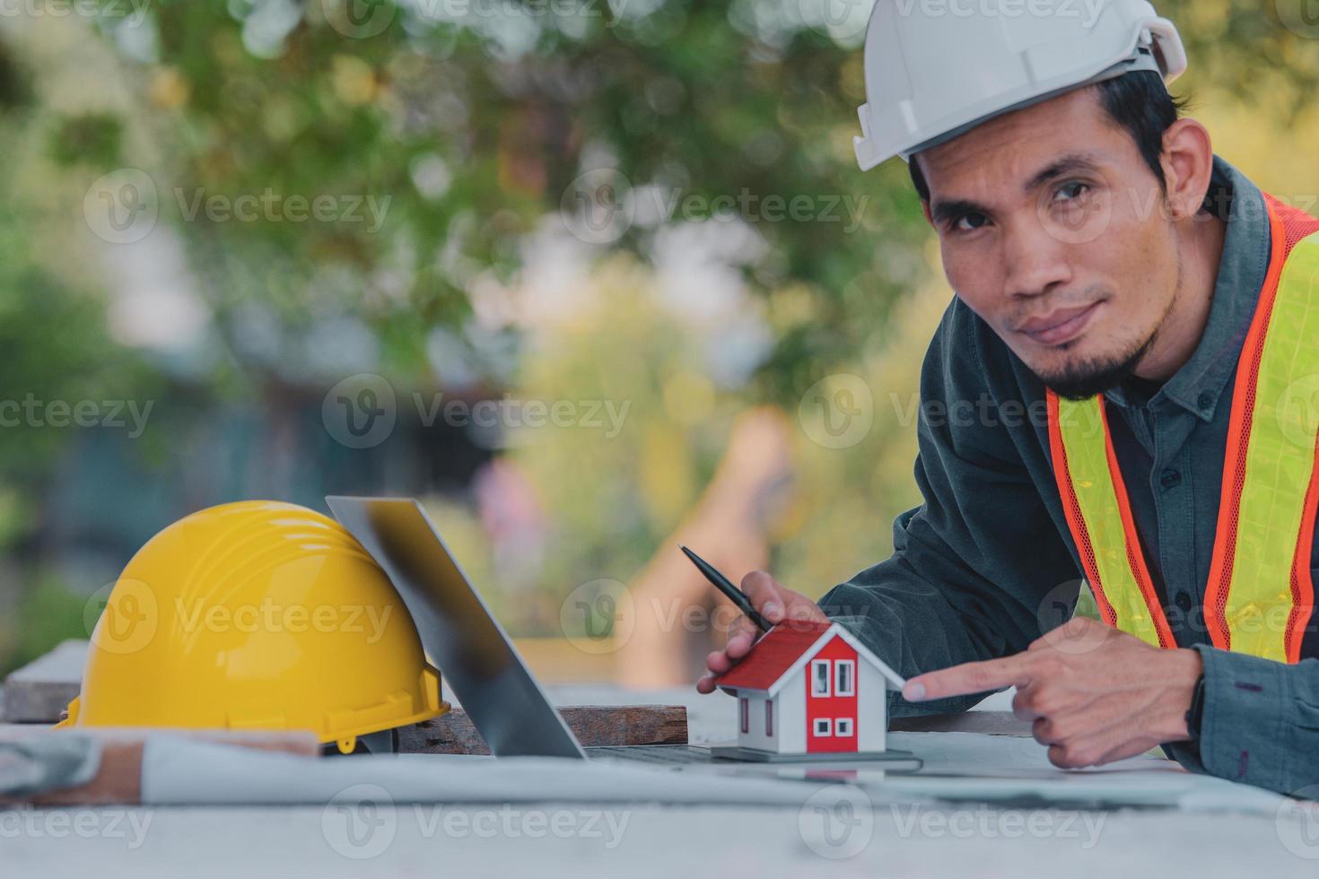 Architectural Engineer designs building construction for a house project photo