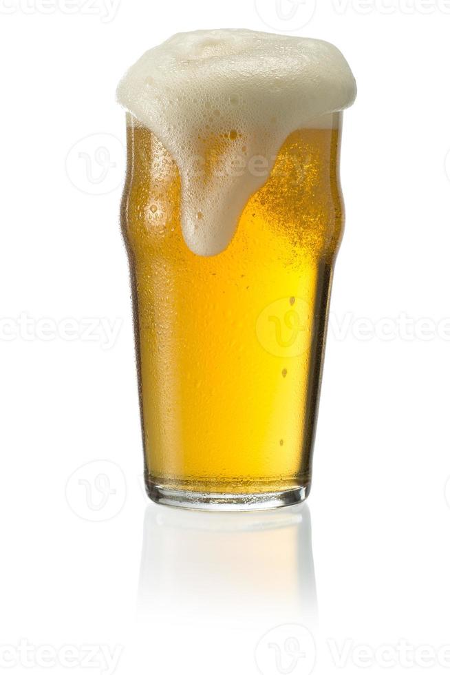 Glass of blonde beer with foam photo