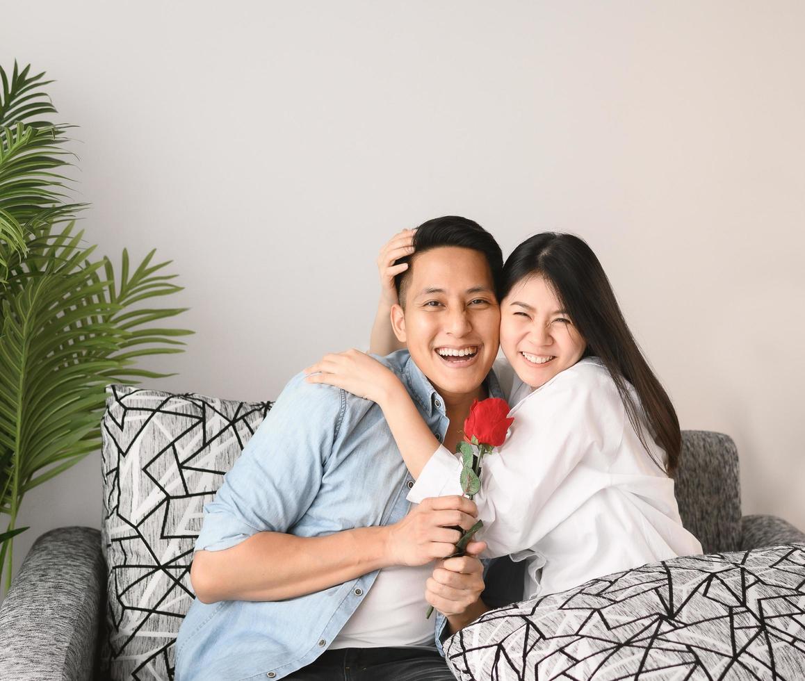 Happy Asian couple hugging and enjoying a good time together photo