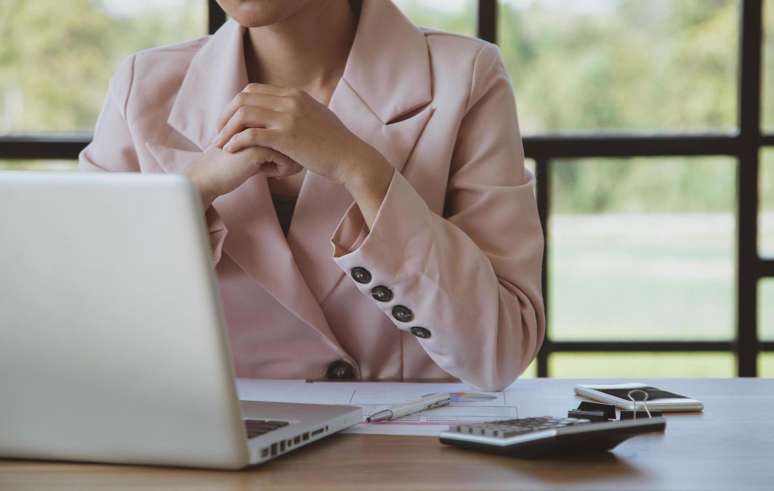 Young businesswoman working on laptop in her workstation photo