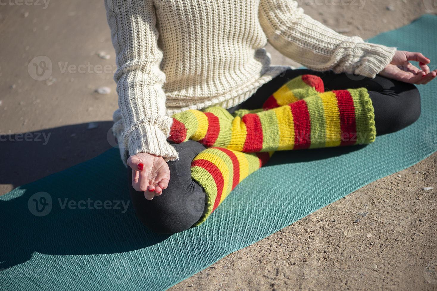 A young athletic woman performs yoga and meditation exercises outdoors photo