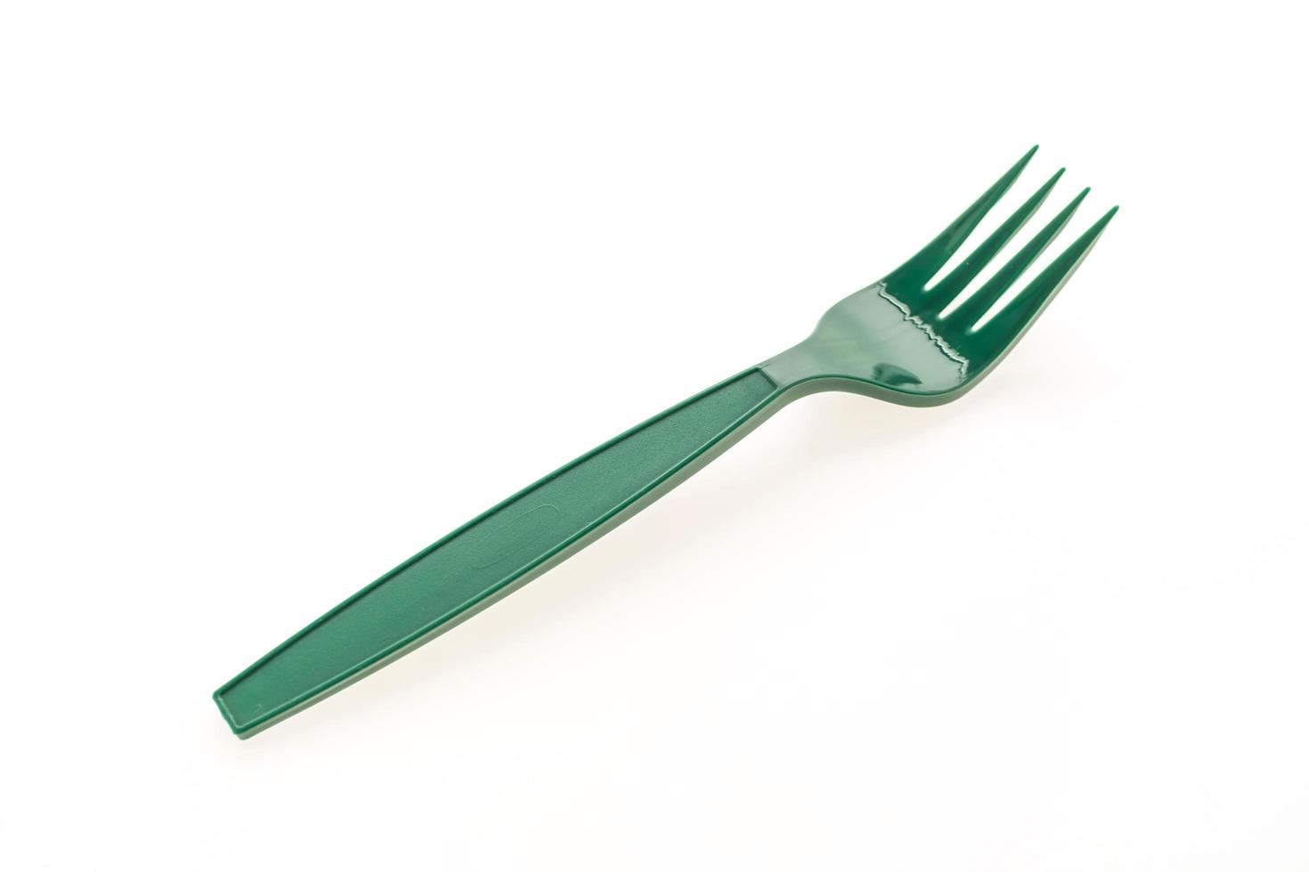 Green plastic fork on white background photo