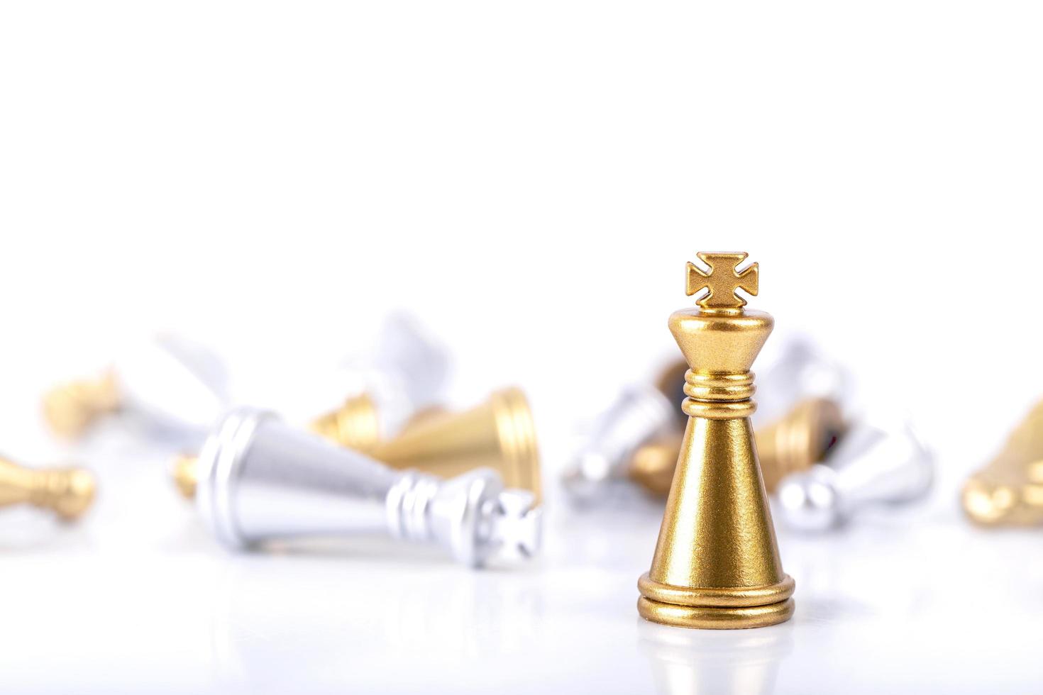 Gold and silver chess pieces on white photo