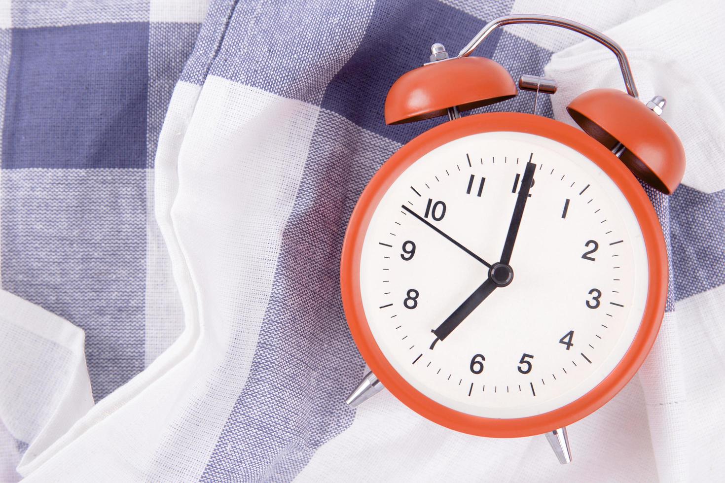 Alarm clock on checkered cloth photo