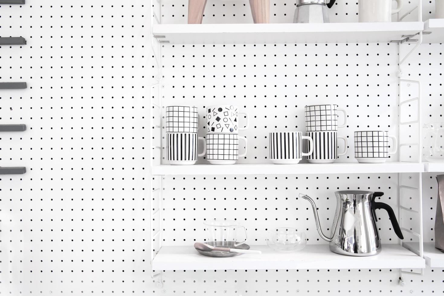 Modern kitchenware and utensils on shelves photo