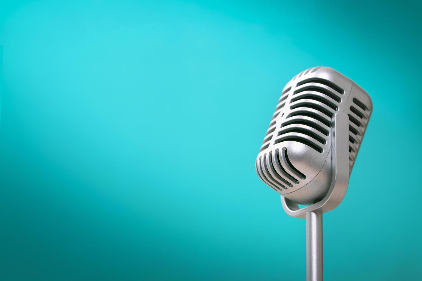 Retro style microphone on green background photo