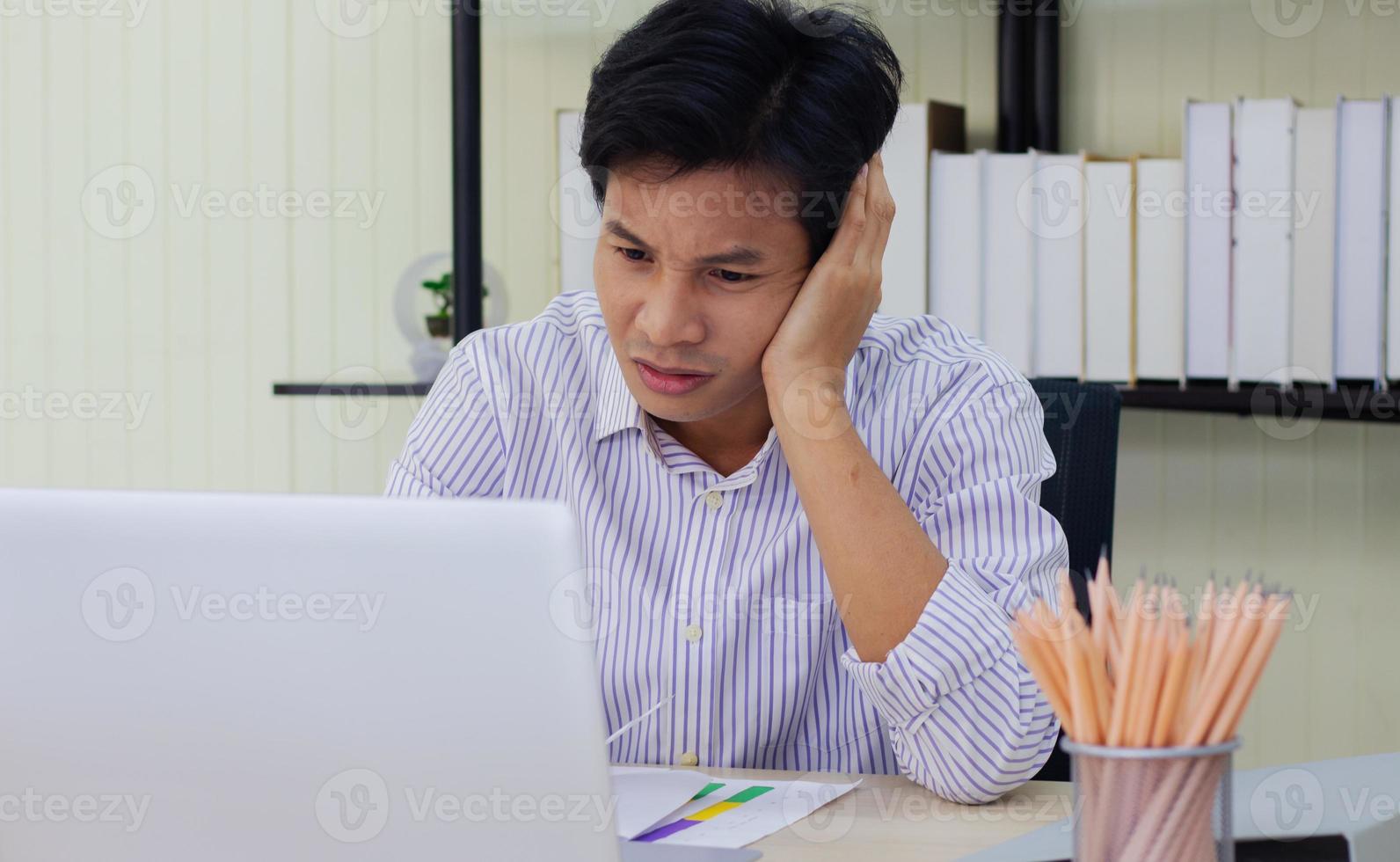 Young businessman stressed at work photo