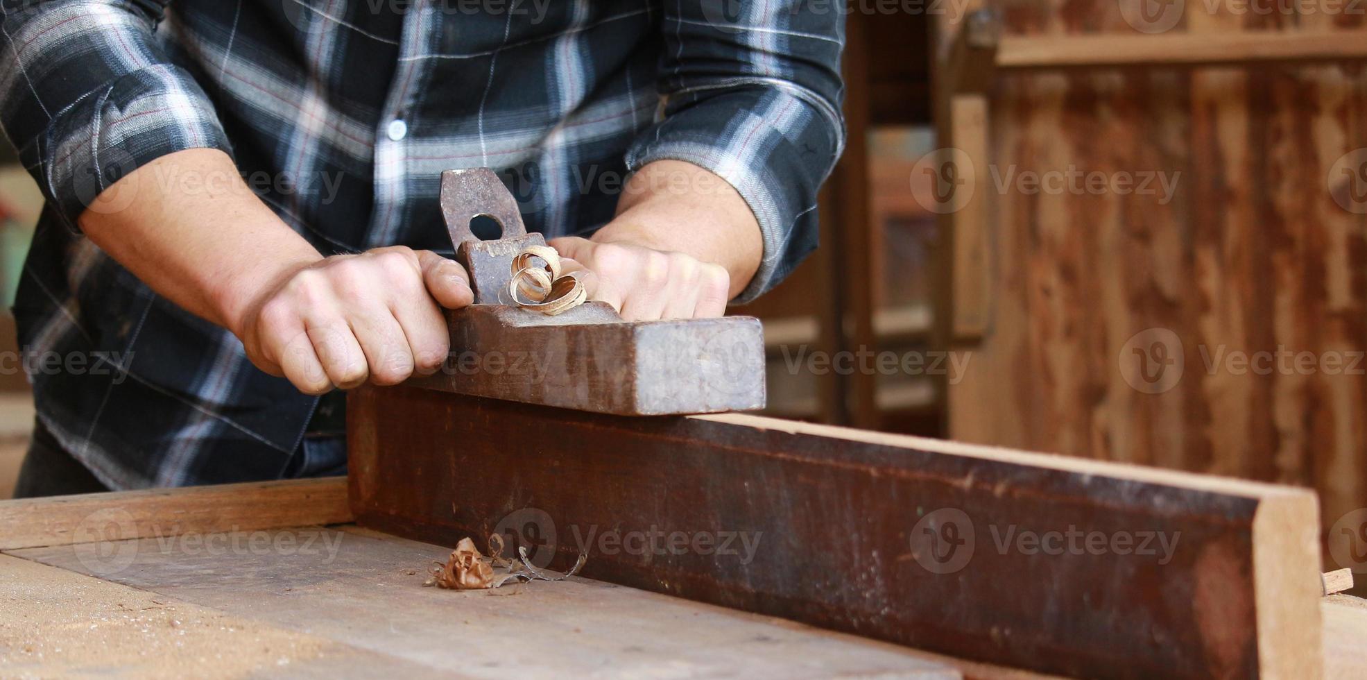 Close-up of a carpenter processing wood photo