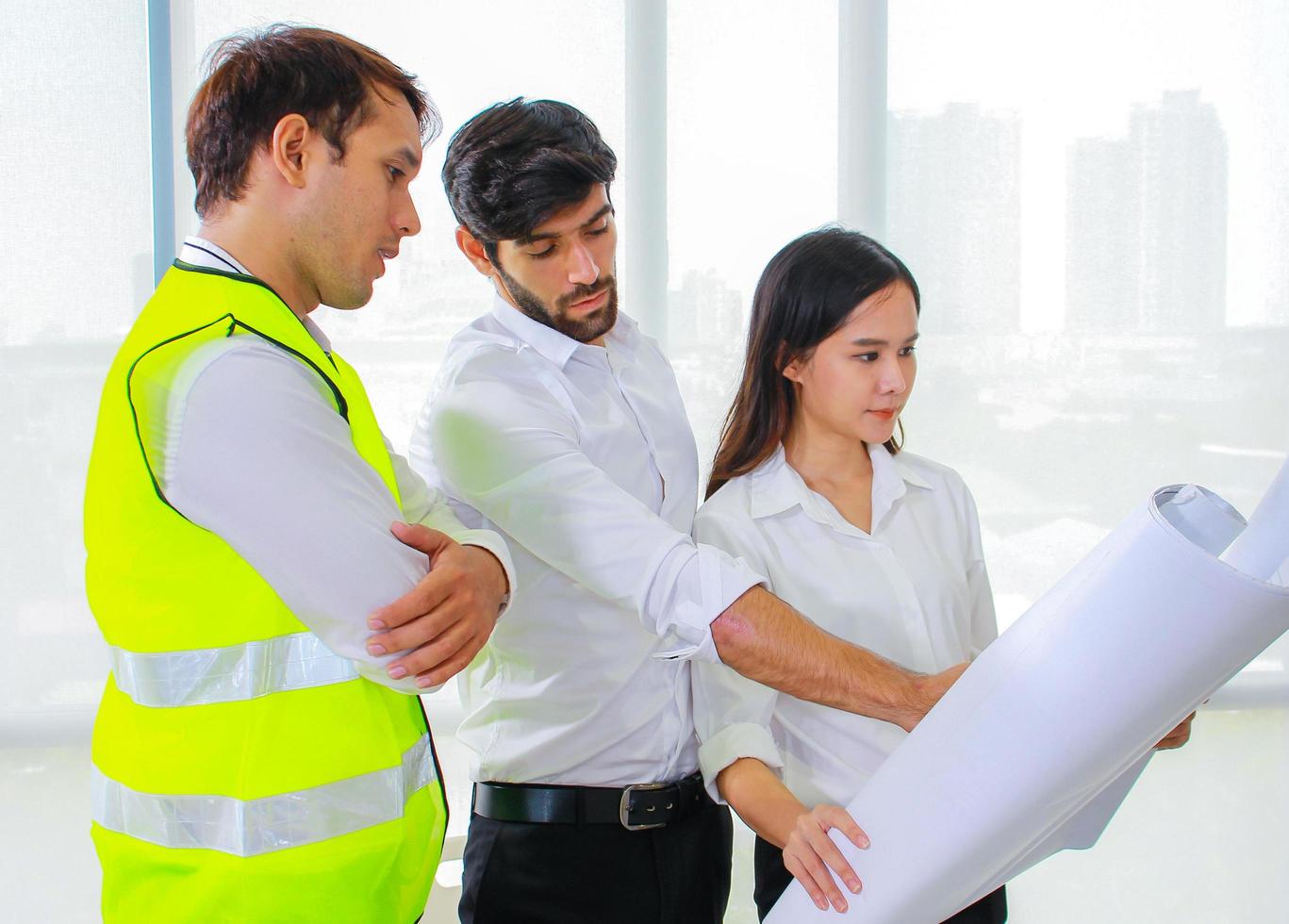 Group of engineers looking at a blueprint photo