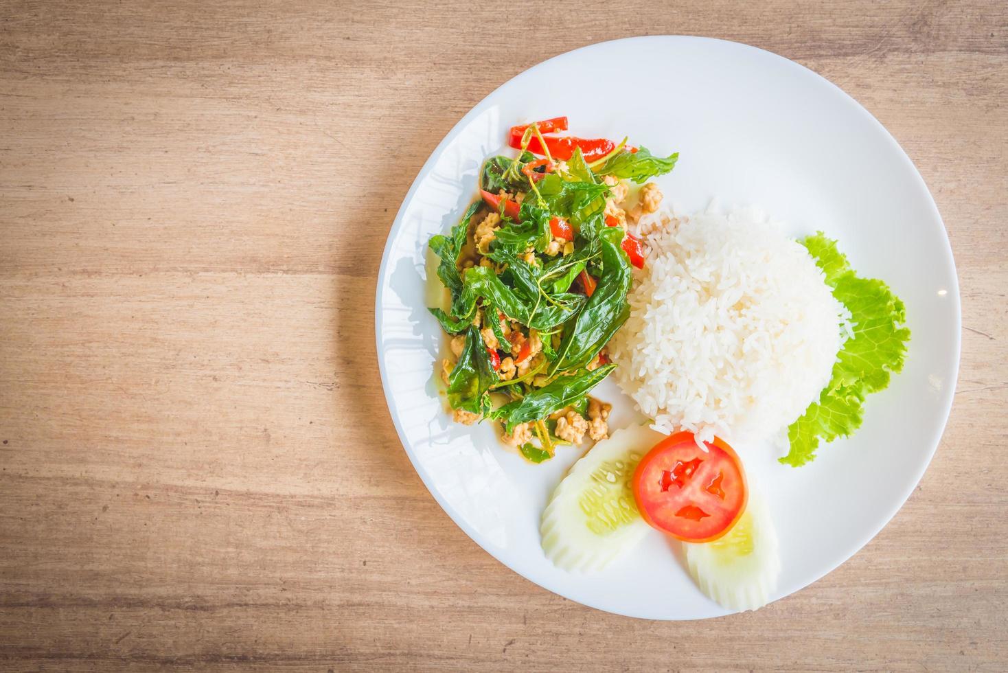 Spicy Fried basil leaf with chicken and rice photo