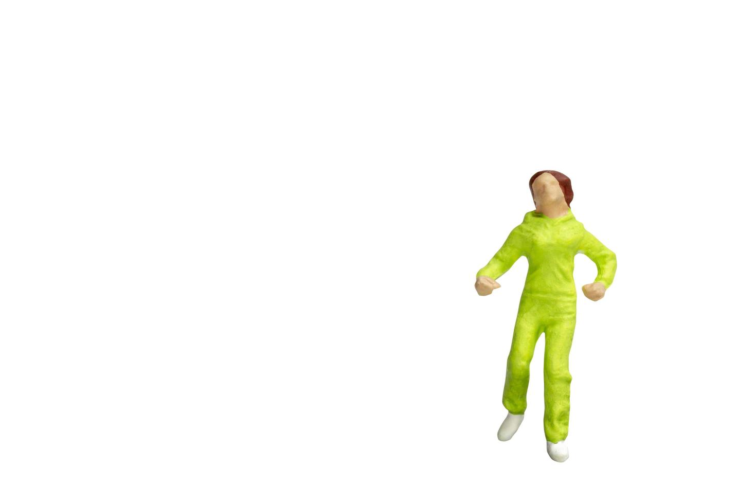 Miniature person running isolated on a white background photo