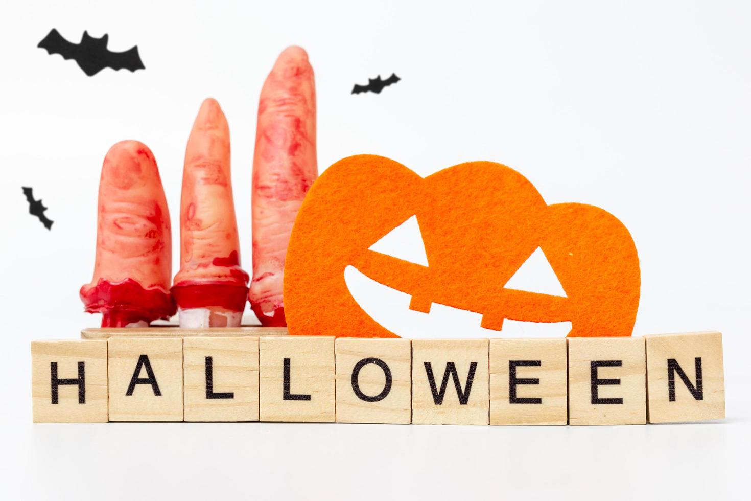 Halloween party props with wooden blocks with the text Halloween on a white background photo