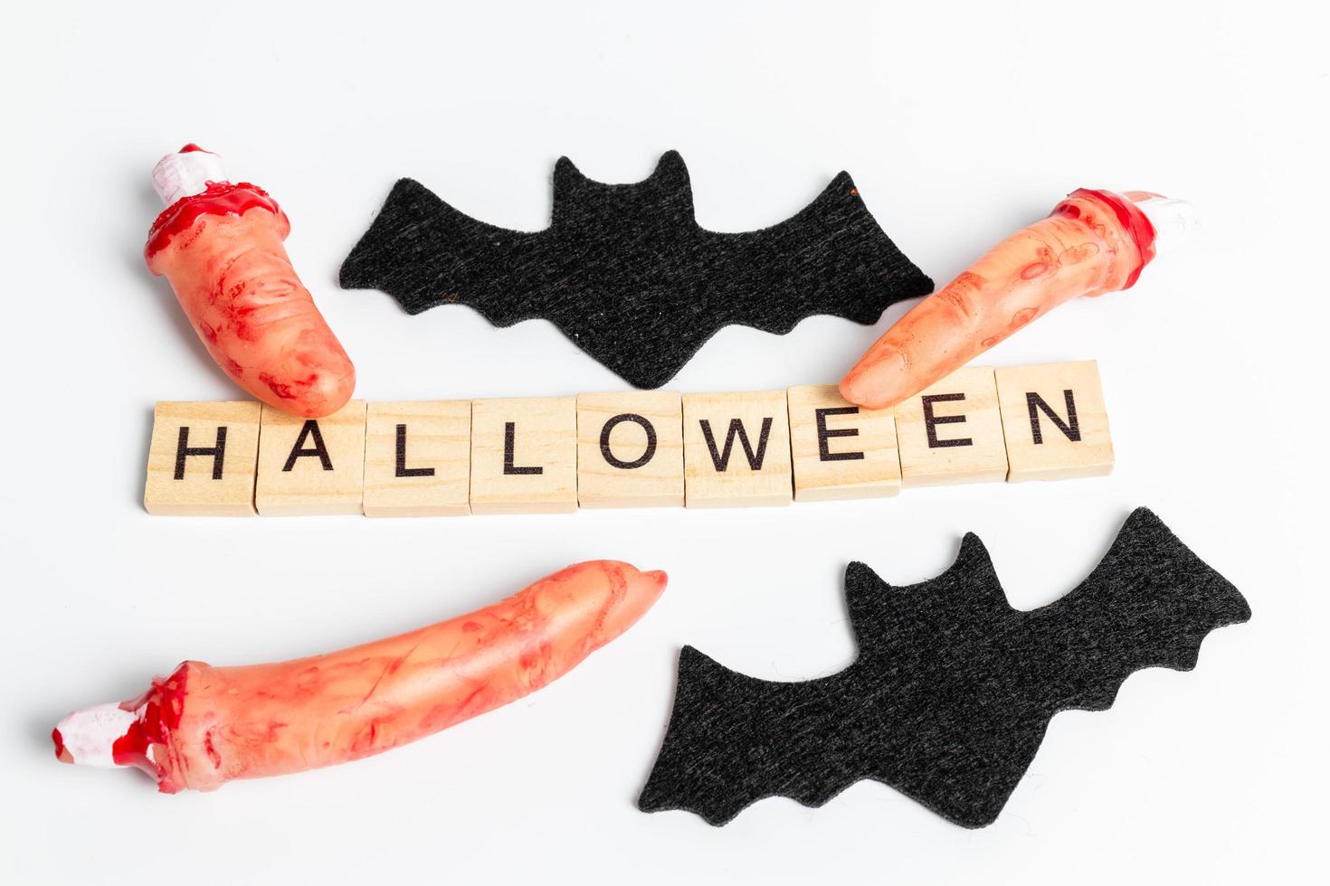 Halloween party props with wooden blocks with the text Halloween on a white background photo