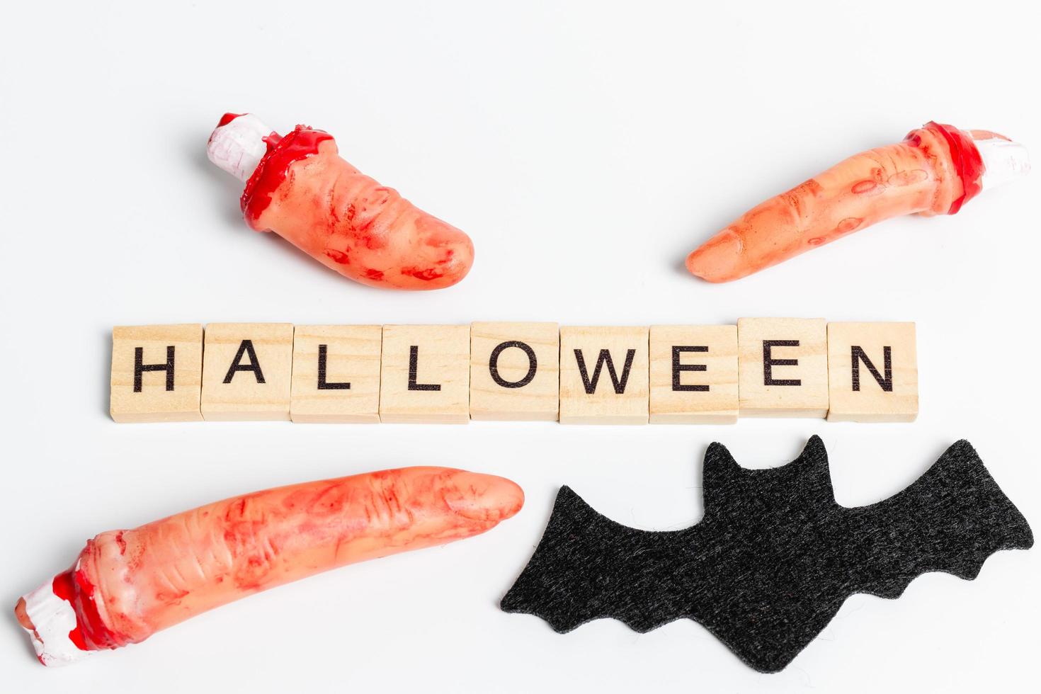Halloween party props with wooden blocks with the text Halloween on a white background photo