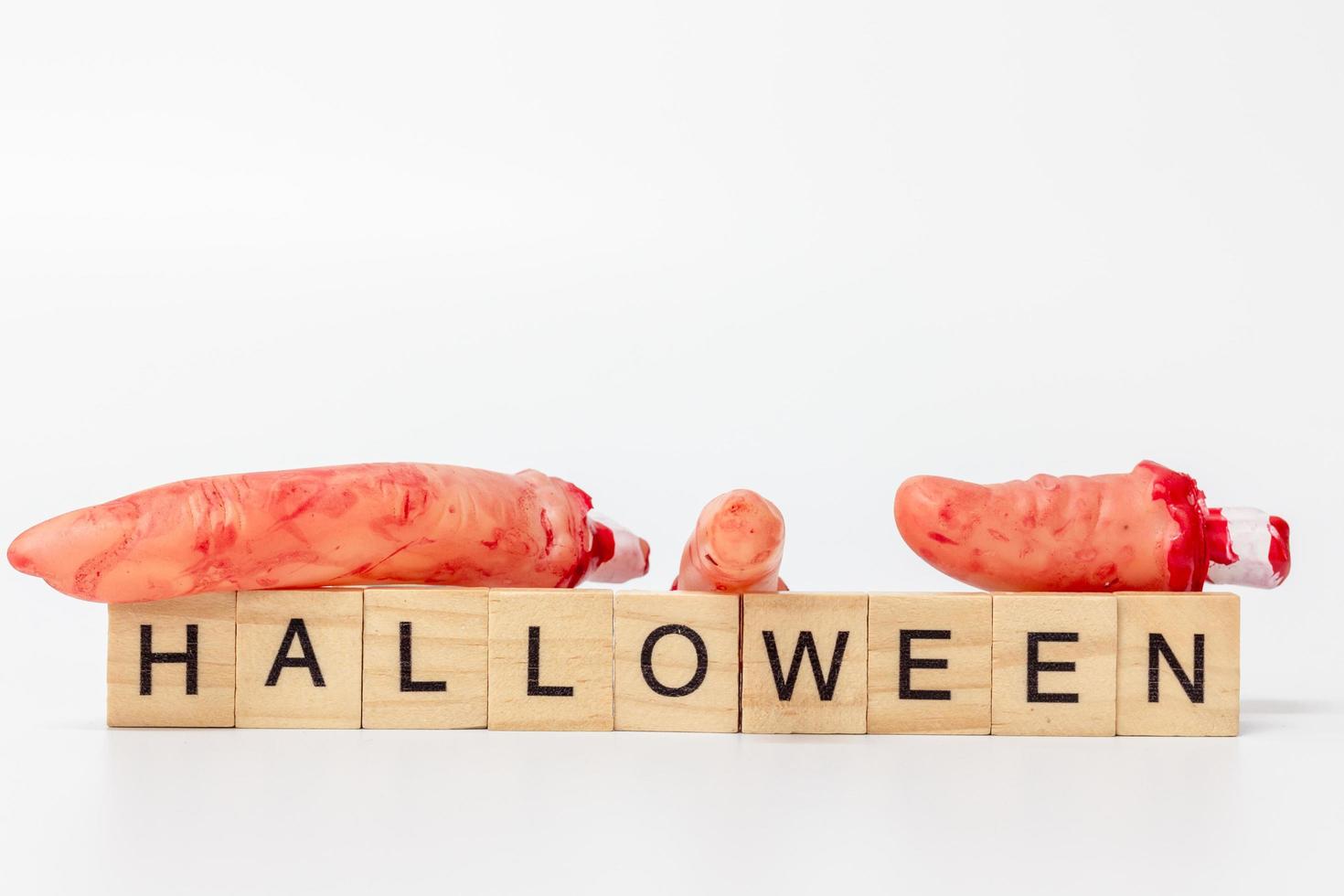 Halloween party props with wooden blocks with the text Halloween on a white background photo