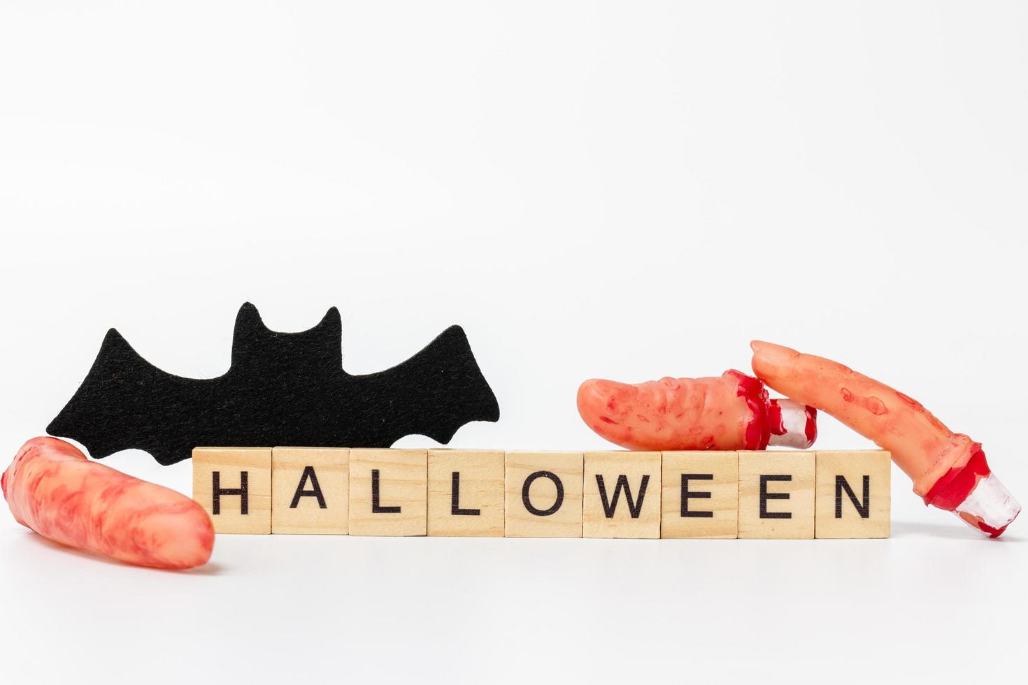 Halloween party props with wooden blocks with the text Halloween on a white background photo