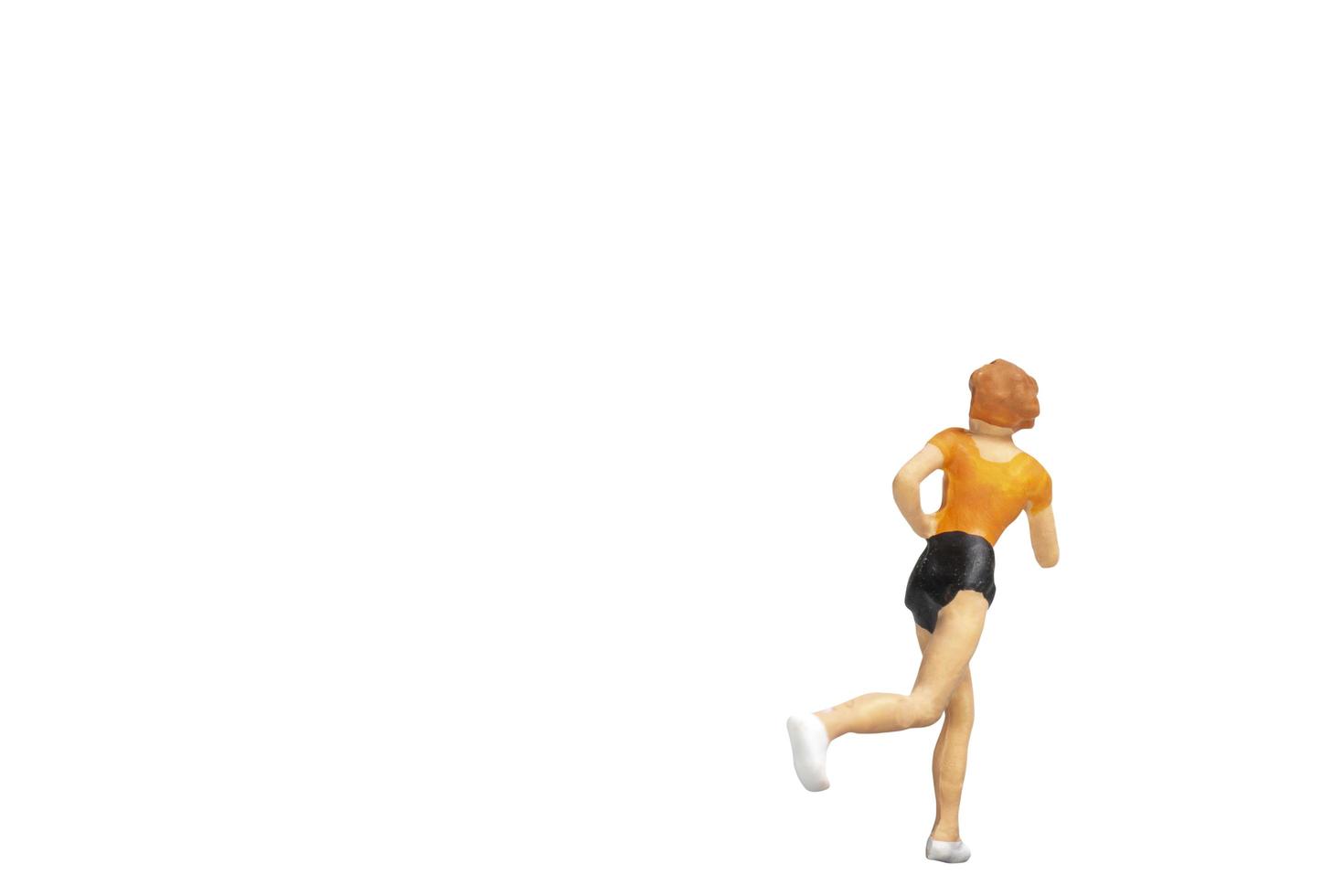 Miniature person running isolated on a white background photo