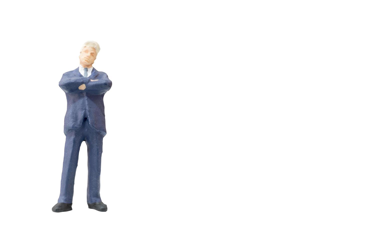 Miniature businessman on a white background photo