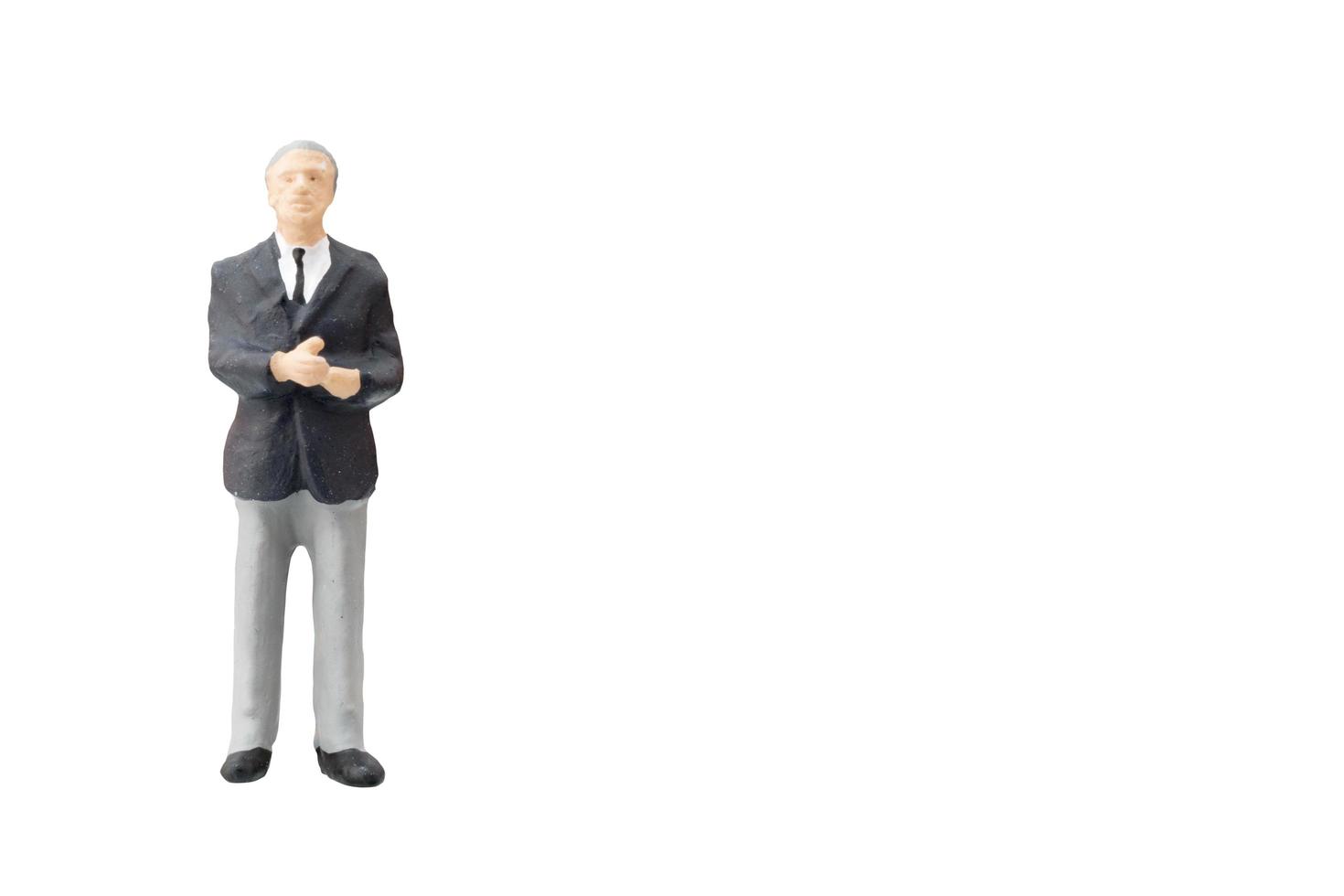 Miniature businessman on a white background photo