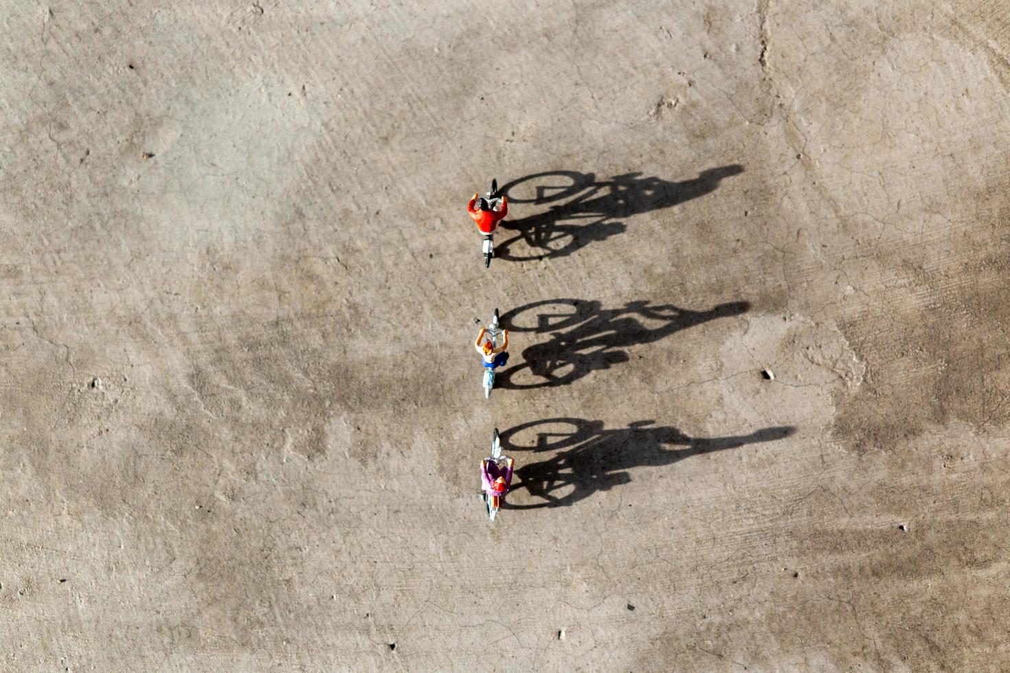 Miniature travelers riding bicycles, healthy lifestyle concept photo
