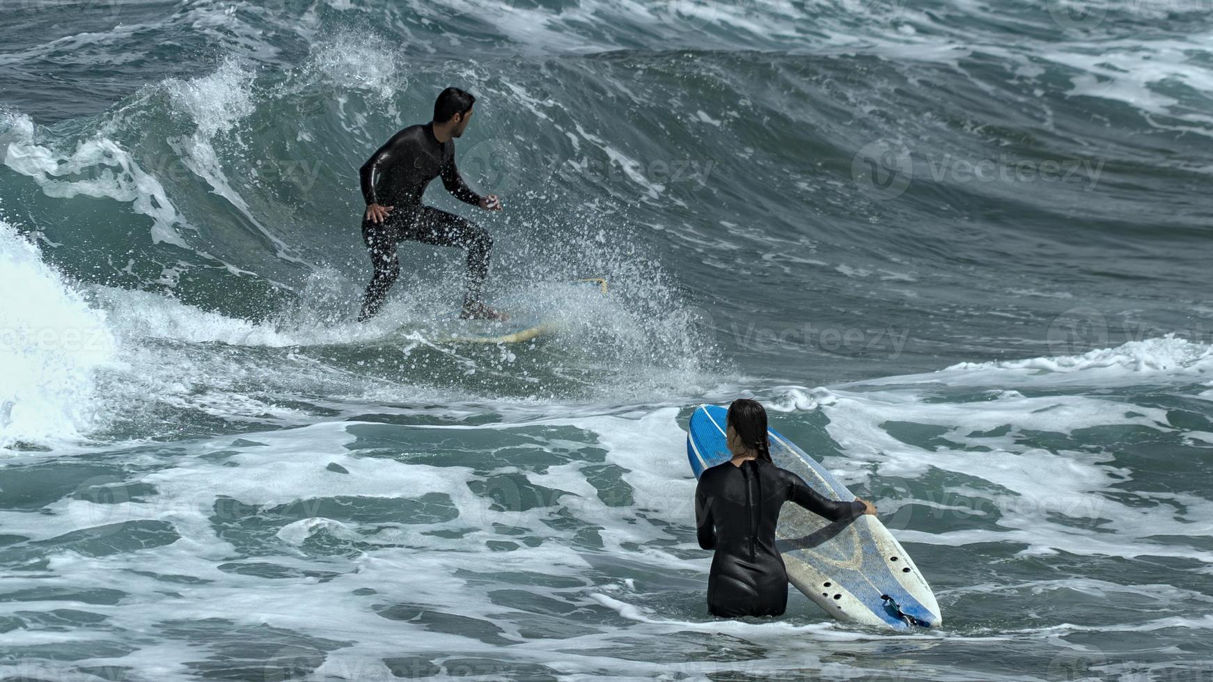 Surfing on the beach of La Cicer in Las Palmas de Gran Canaria photo